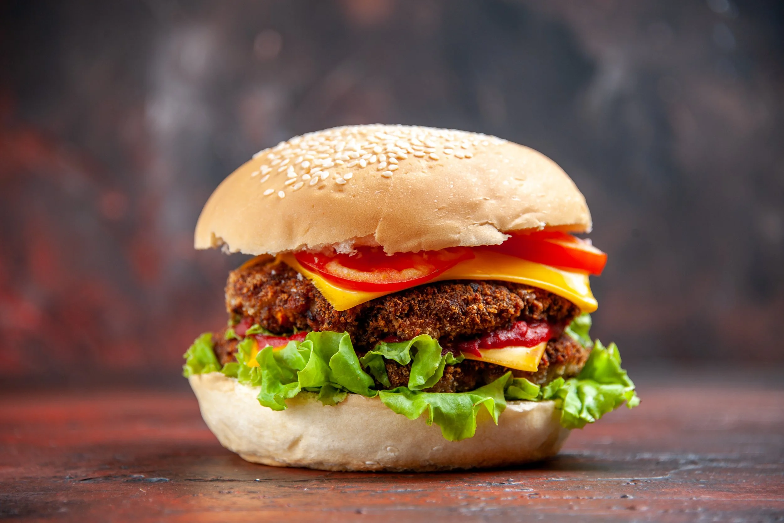 front-view-tasty-meat-burger-with-cheese-salad-dark-background.jpg