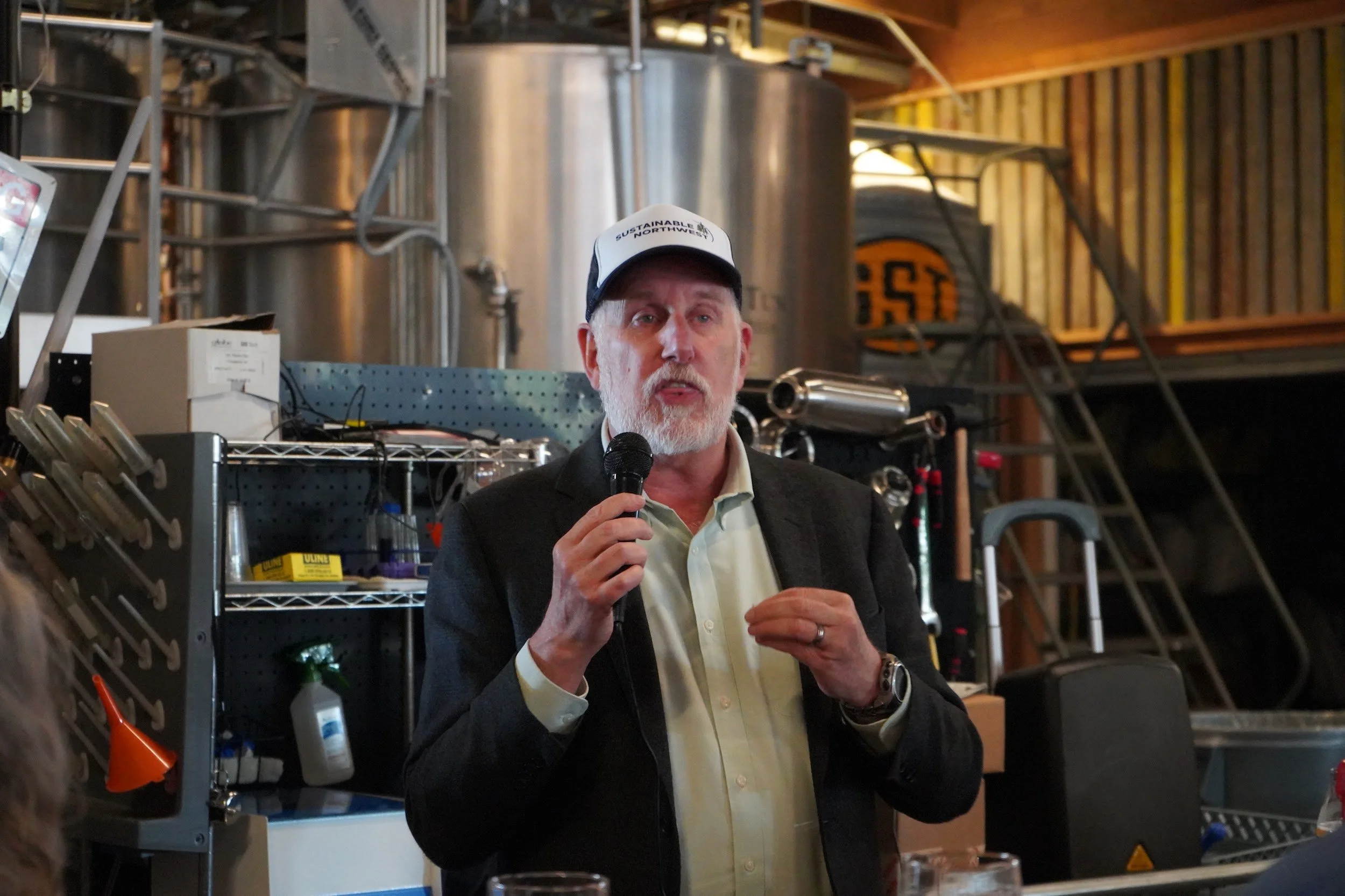 Speaker addressing symposium attendees inside Fort George Brewery.jpg