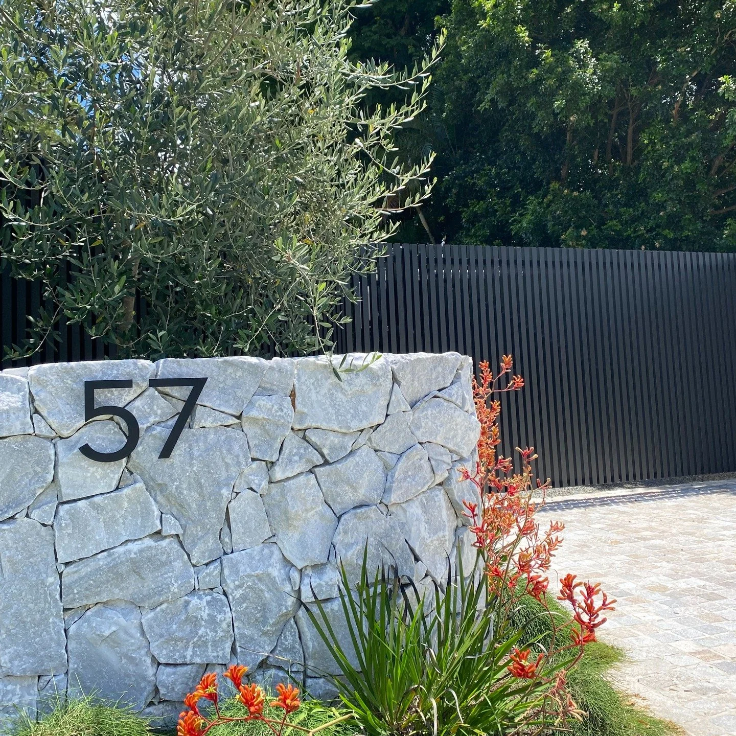 A bold and welcoming entry defined by layered planting, crafted stonework and tailored proportions. 

#brisbanegardens #landscapedesign #gardendesigner #gardens #subtropicalgarden #myverandah