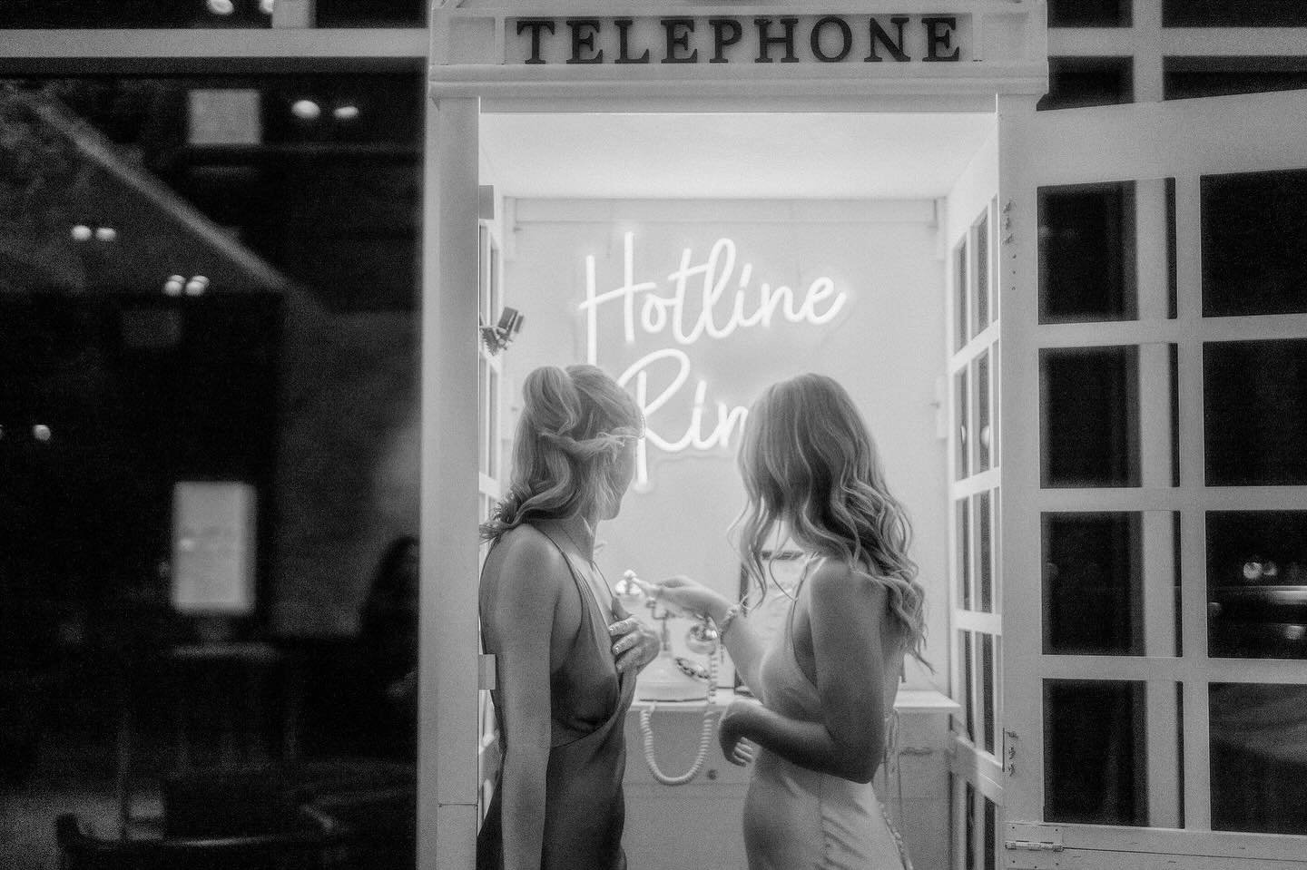 Some moments feel straight out of an old film &mdash;
two girls, one phone booth, and a whole lot of fun.
Black and white makes it timeless, but the laughter makes it unforgettable.

Who needs filters when the vibe is this iconic?

Wedding Planner @c