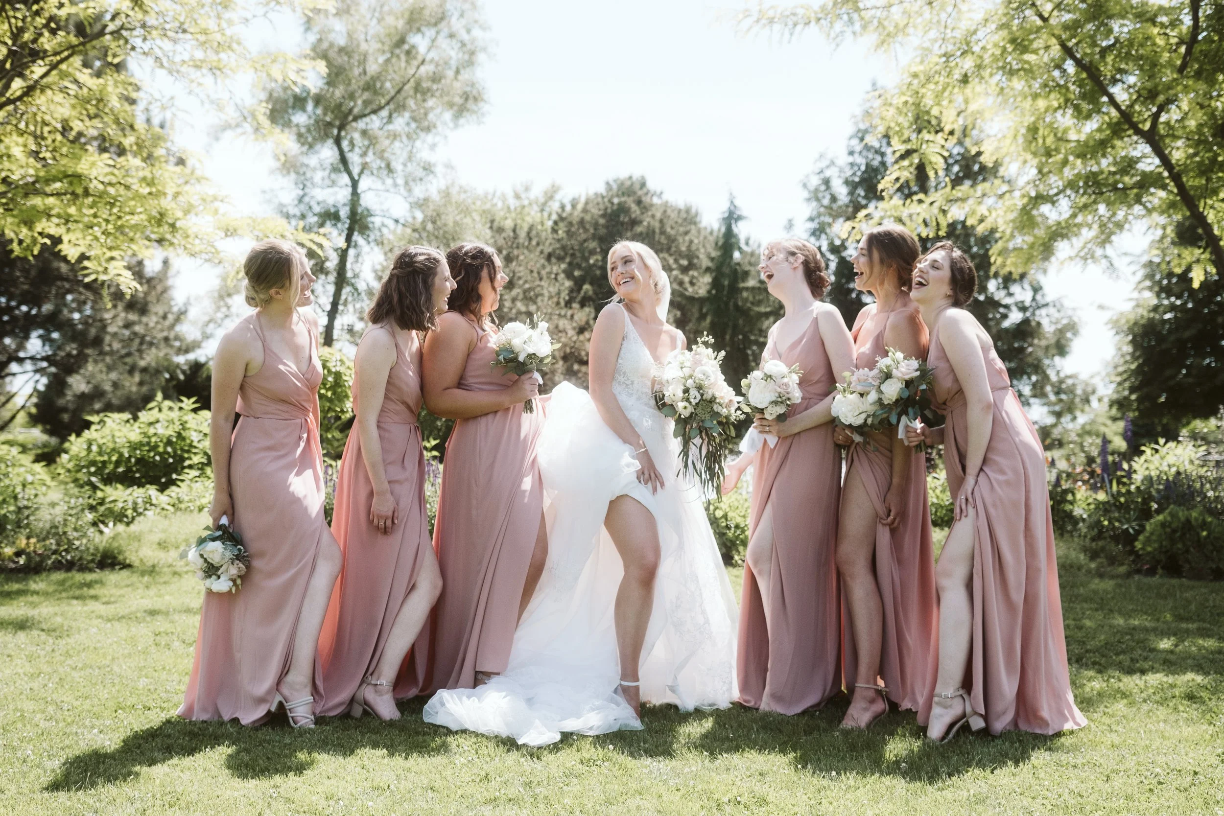 bride with bridal party laughing at the hessenland inn & schatz winery
