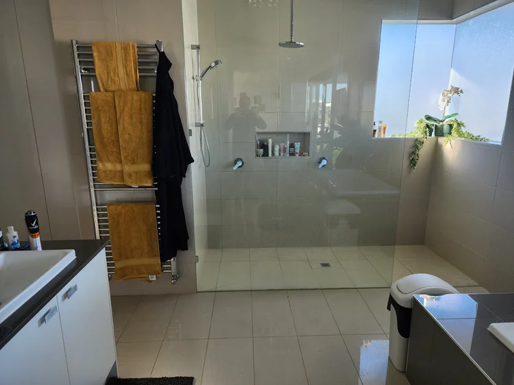 Bathroom with a walk-in shower checked for a waterproofing leak