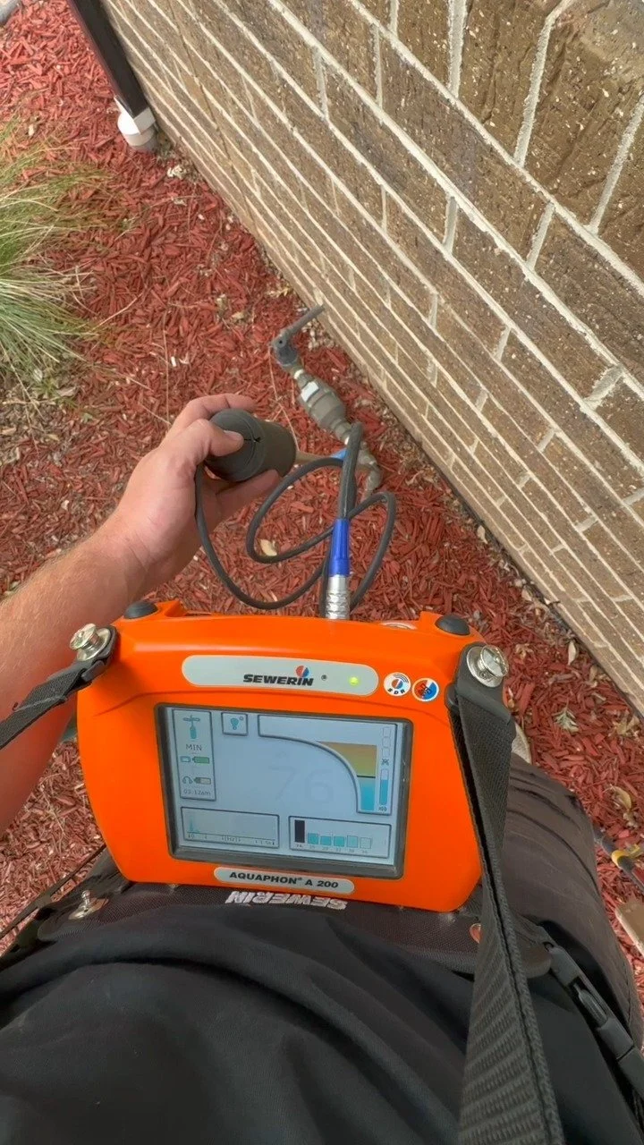 Electronic leak detector used on gravel beside a gas line