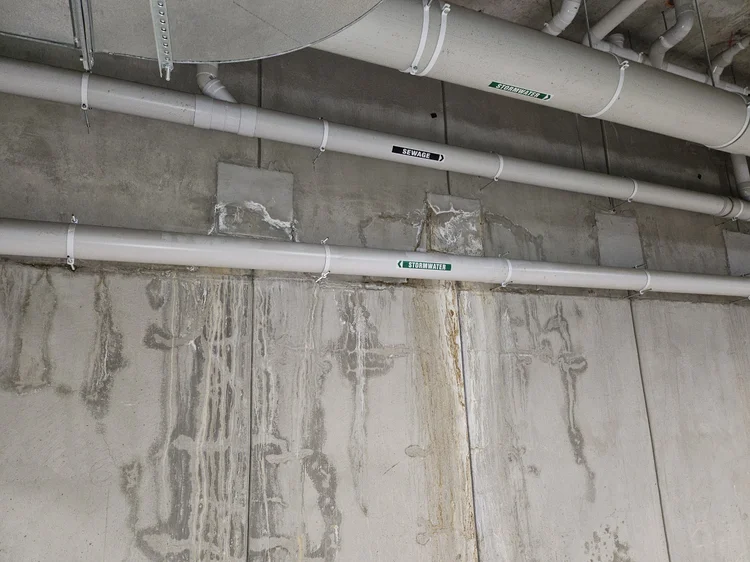 Pipes along a basement car park ceiling in a unit block