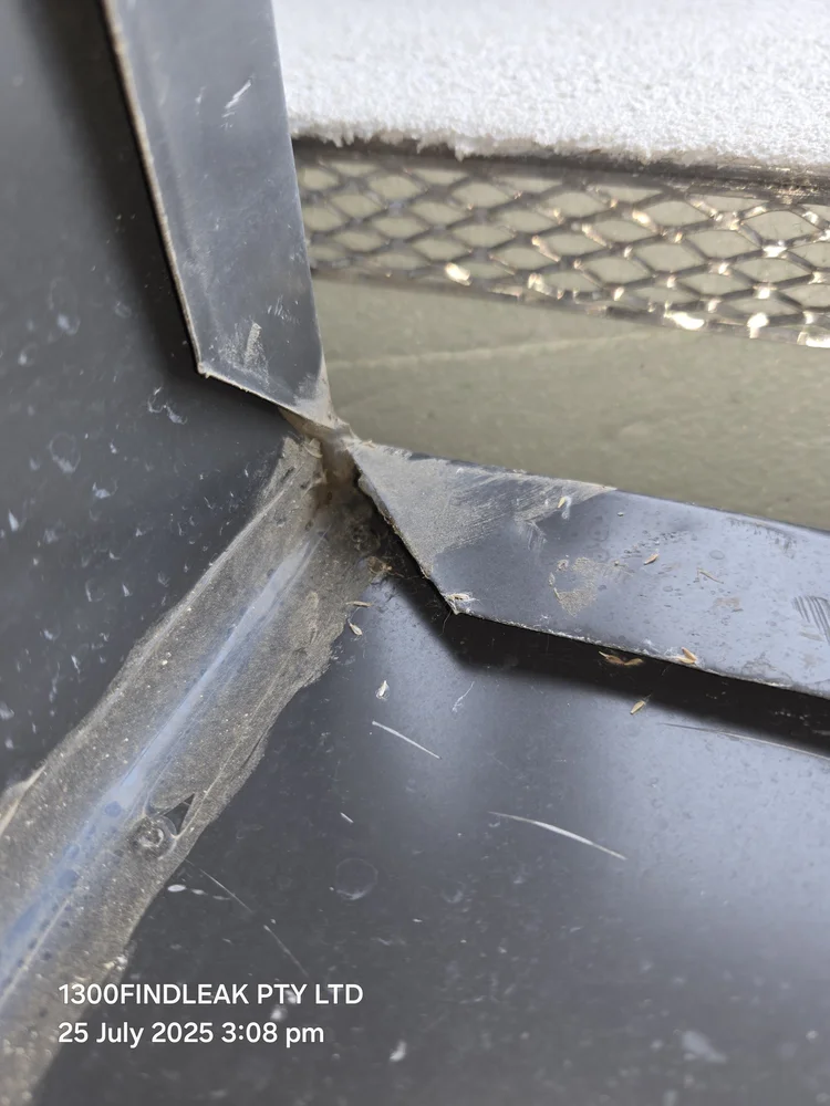 Box gutter flashing checked for water entry after heavy rain
