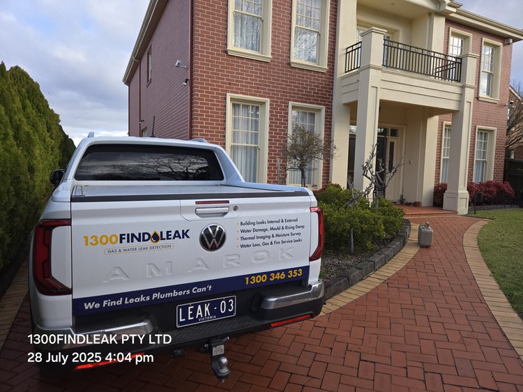 1300 FINDLEAK ute parked outside a brick home