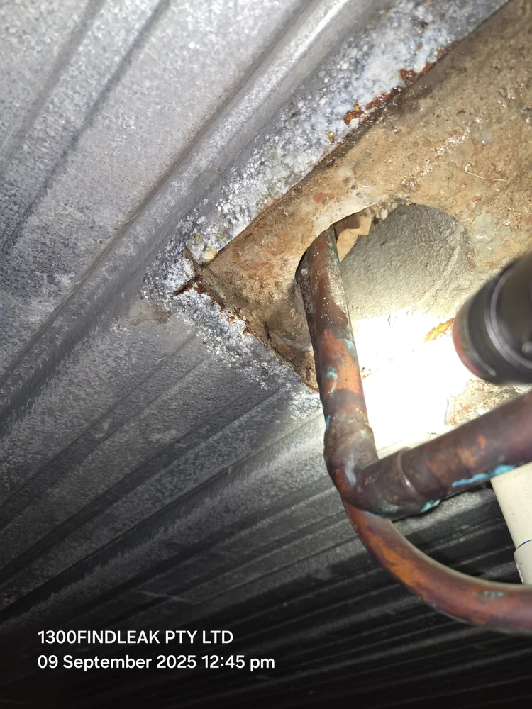 Copper water pipe exposed at the exact point of a leak