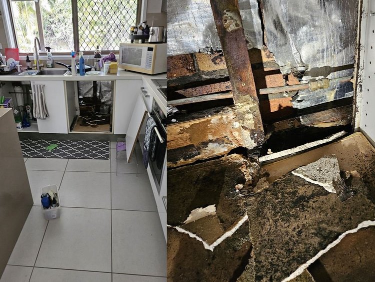 Kitchen floor opened to show a leaking pipe under a slab