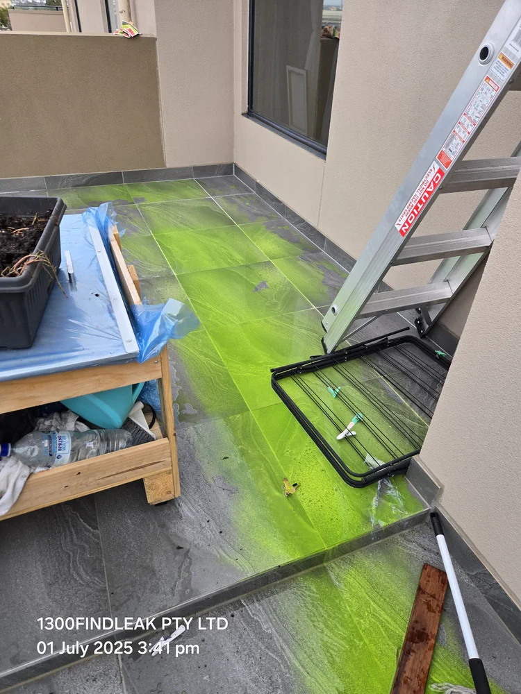 UV tracer dye glowing on a roof skylight during a leak test