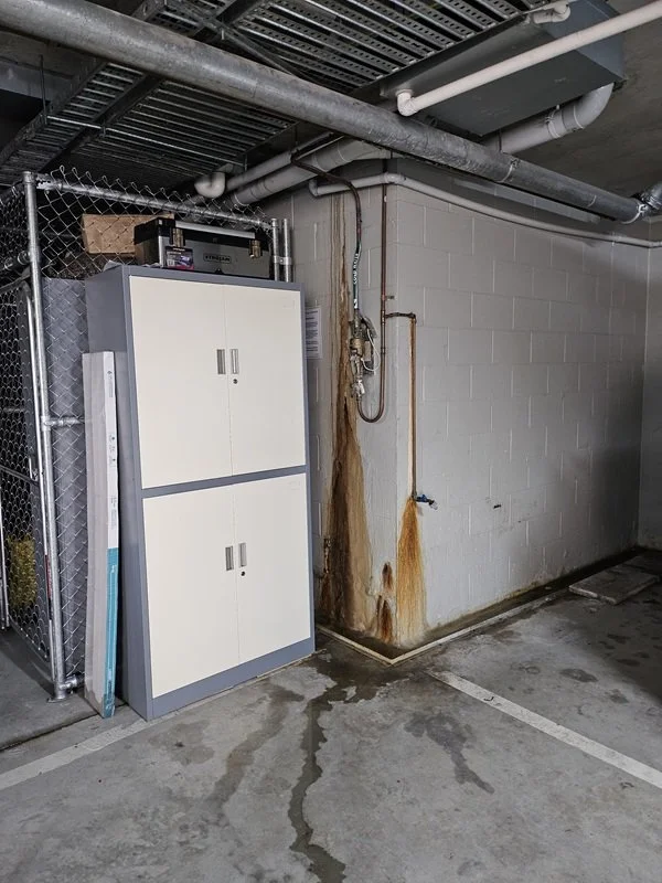 Acoustic leak detection equipment being used on a concrete floor in a Crows Nest commercial building.