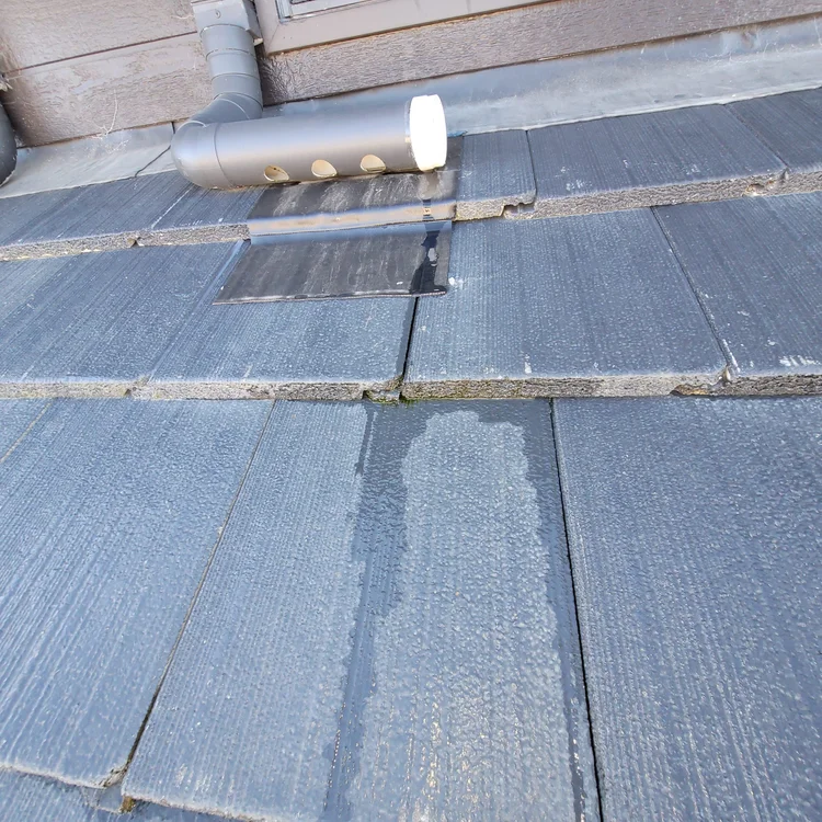 Water trail across a concrete garage floor from a hidden leak