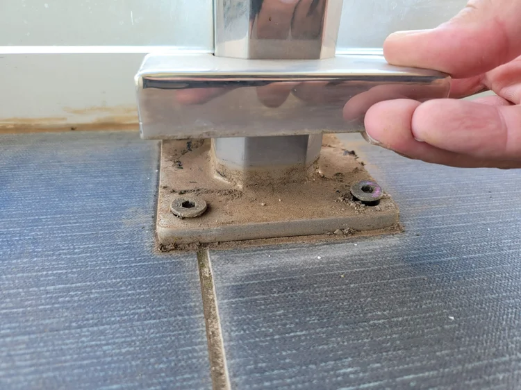 Corroded balustrade base plate letting water into a balcony