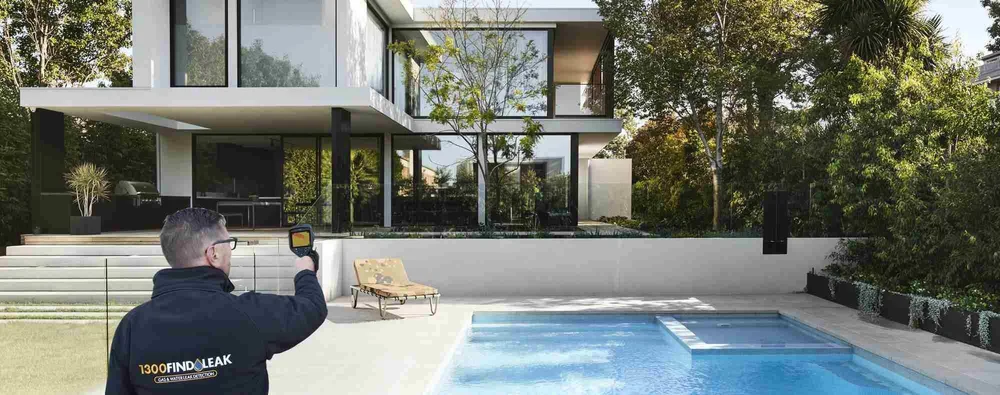 1300 FINDLEAK technician with a thermal camera beside a Melbourne pool