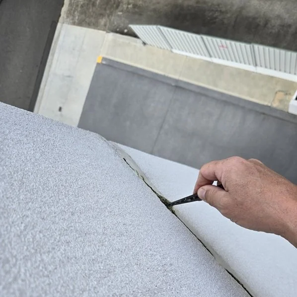 Forensic acoustic leak detection specialist using ultra-sensitive microphones to locate a pinhole pipe burst under a hydronic heated slab.