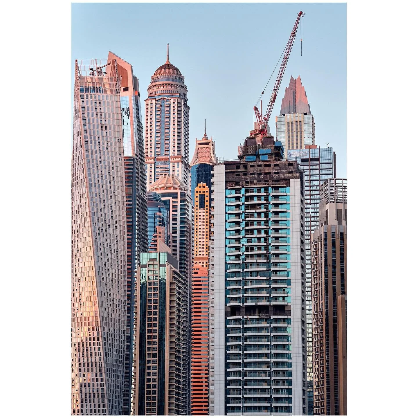 Building buildings 
Dubai marina skyscrapers with the Cayan, Princess and Marina 101 in sight. The density and the size of these buildings are impressive. Caught during golden hour with Fujifilm X-Pro3. 
-
-
-
-
-
-
-
-
-
-
-
-
#mydubai #myfujilove #