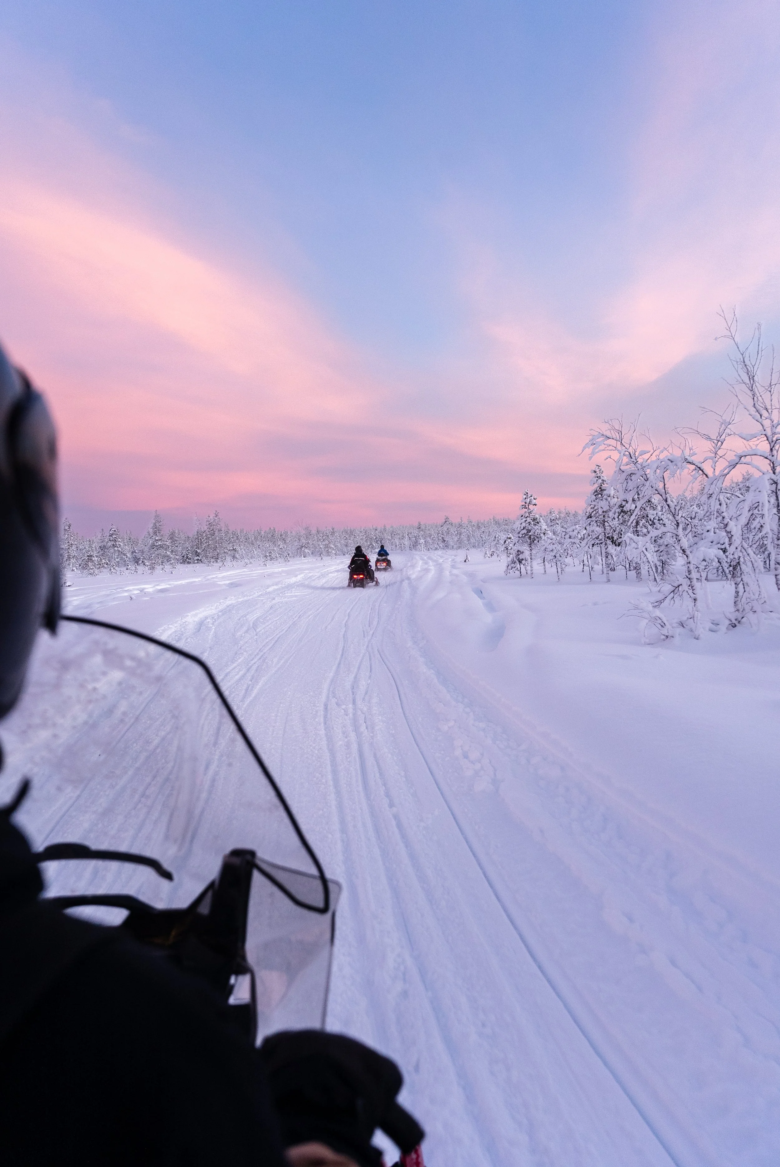 Snowmobiling adventure across frozen landscapes in Luosto, Finnish Lapland