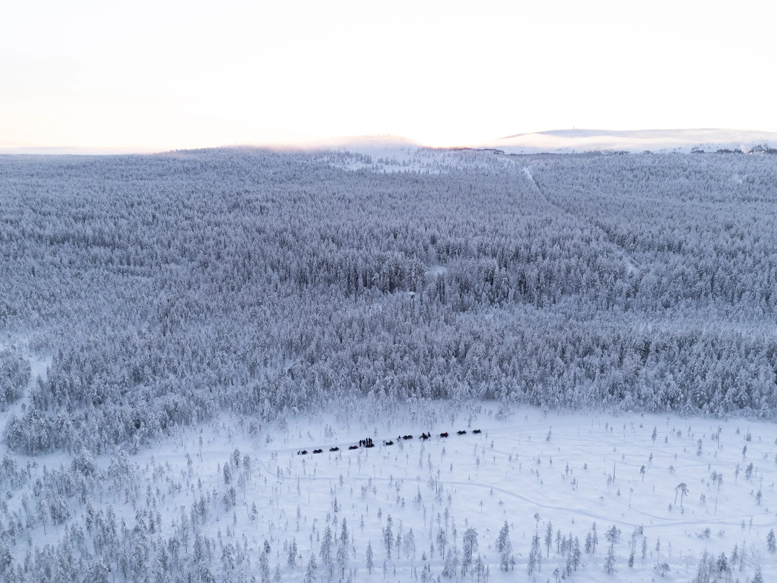Snowmobiling adventure across frozen landscapes in Luosto, Finnish Lapland