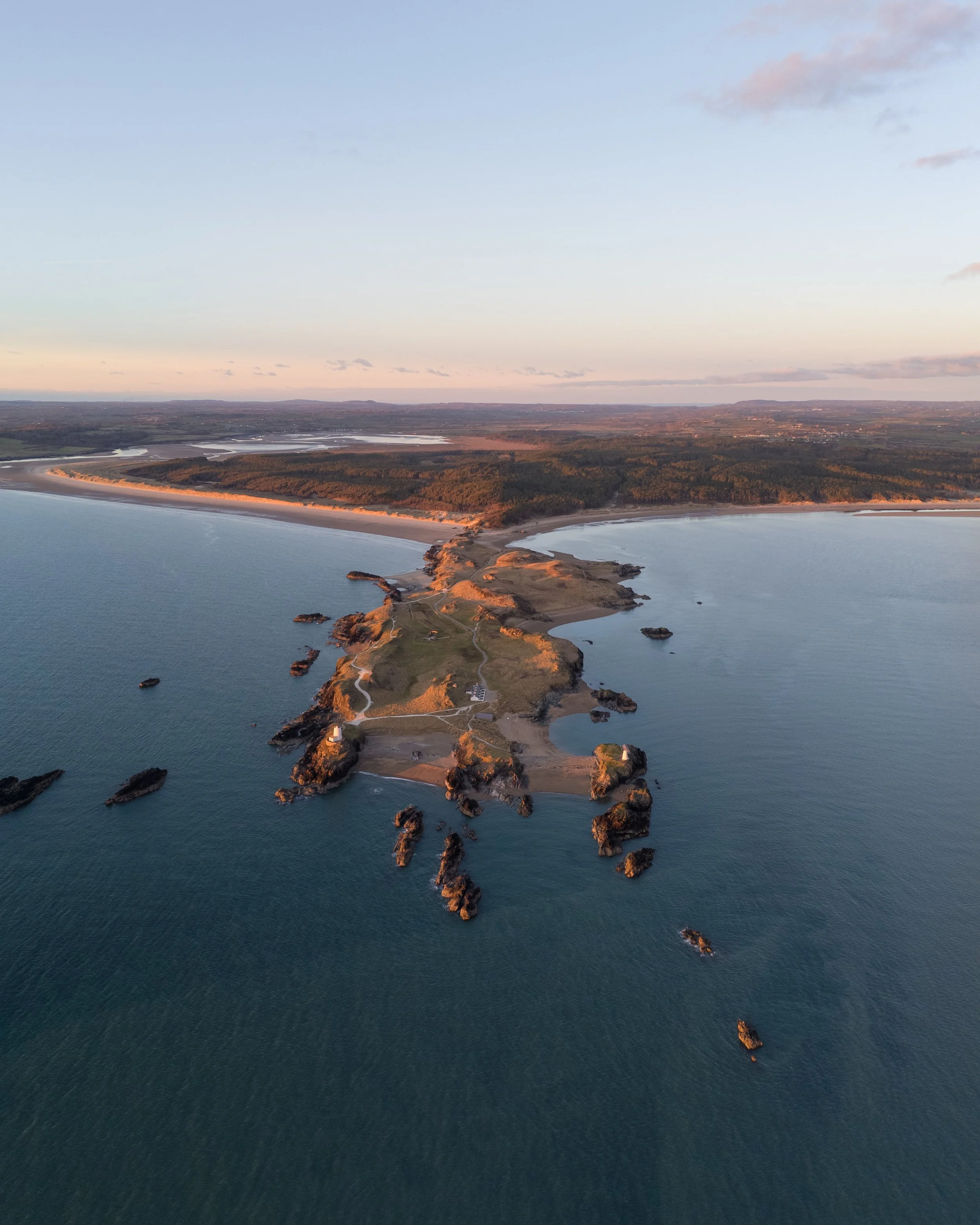 Newborough Beach and Ynys Llanddwyn lighthouse at sunset, Anglesey North Wales