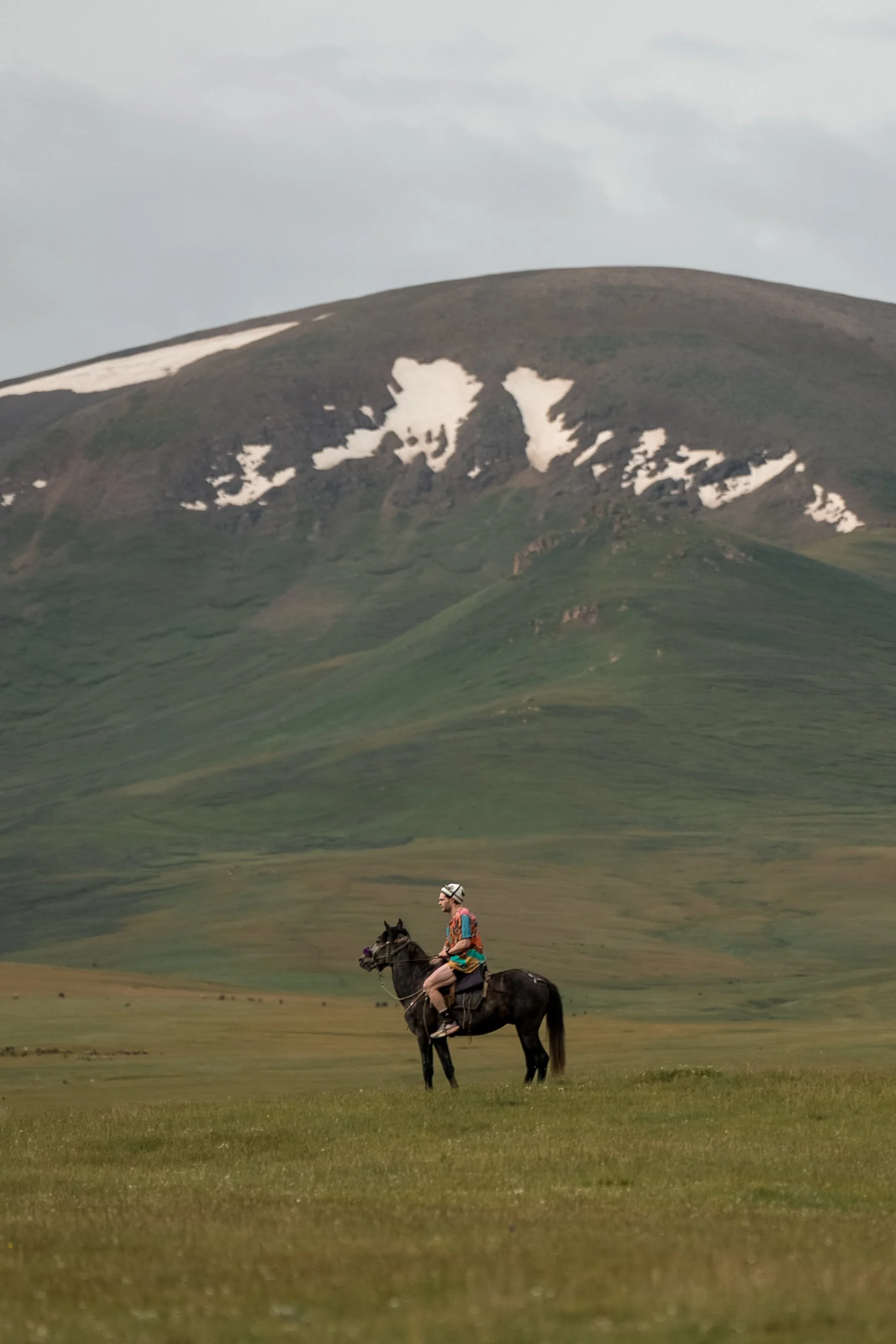 Horseriding across Song-Kul steppe in Kyrgyzstan