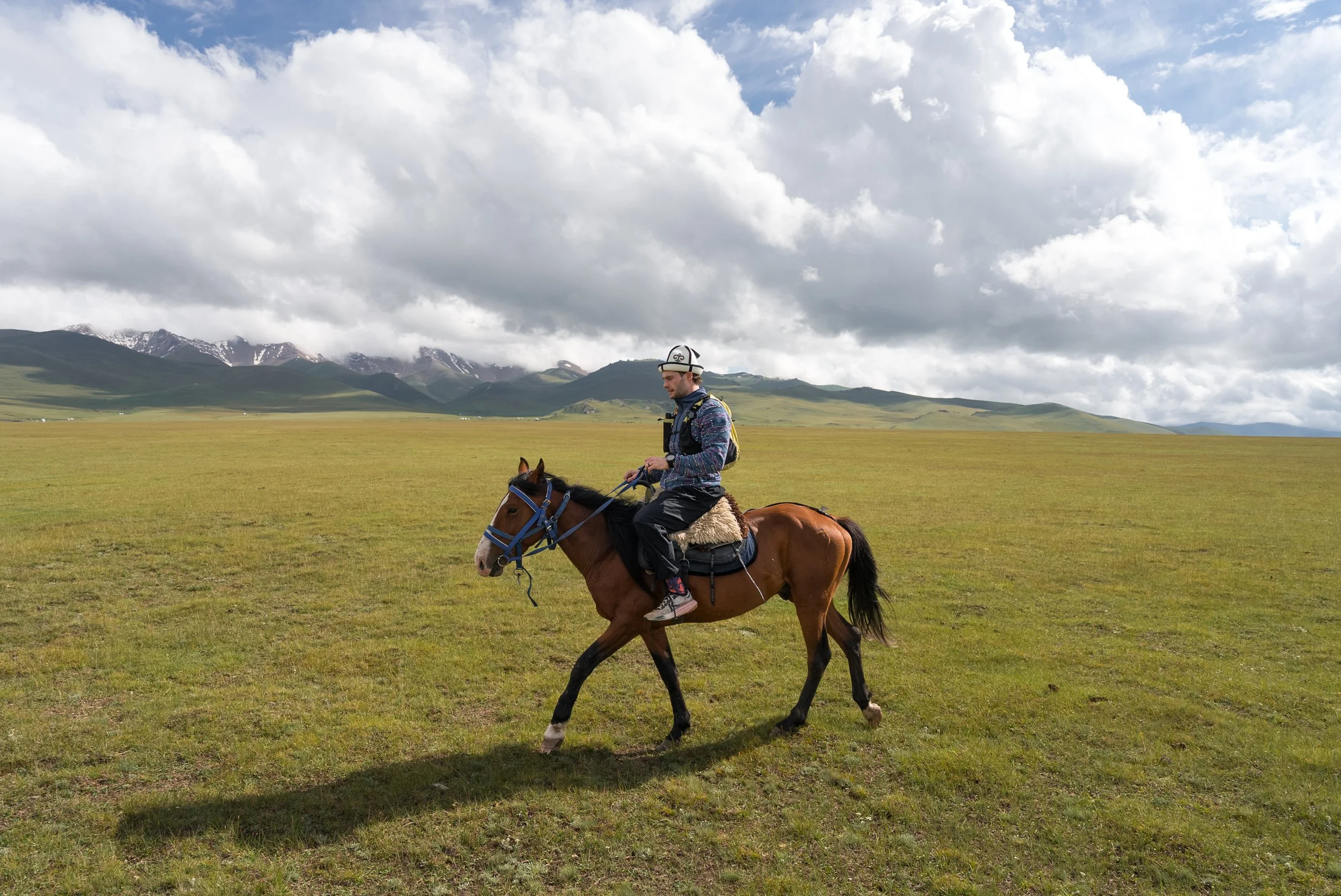 Horseriding across the Song-Kul steppe in Kyrgyzstan