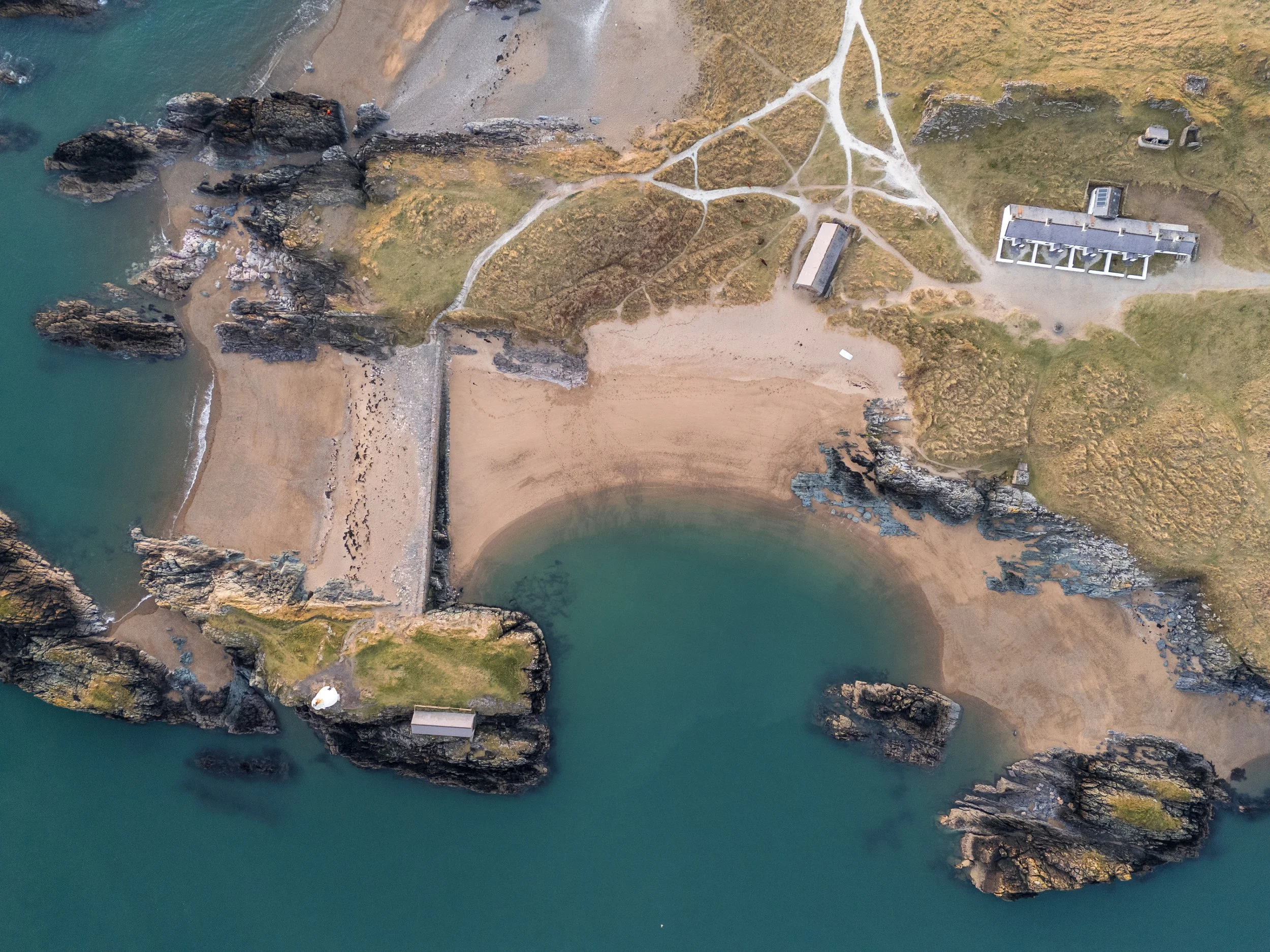 Newborough Beach and Ynys Llanddwyn lighthouse at sunset, Anglesey North Wales