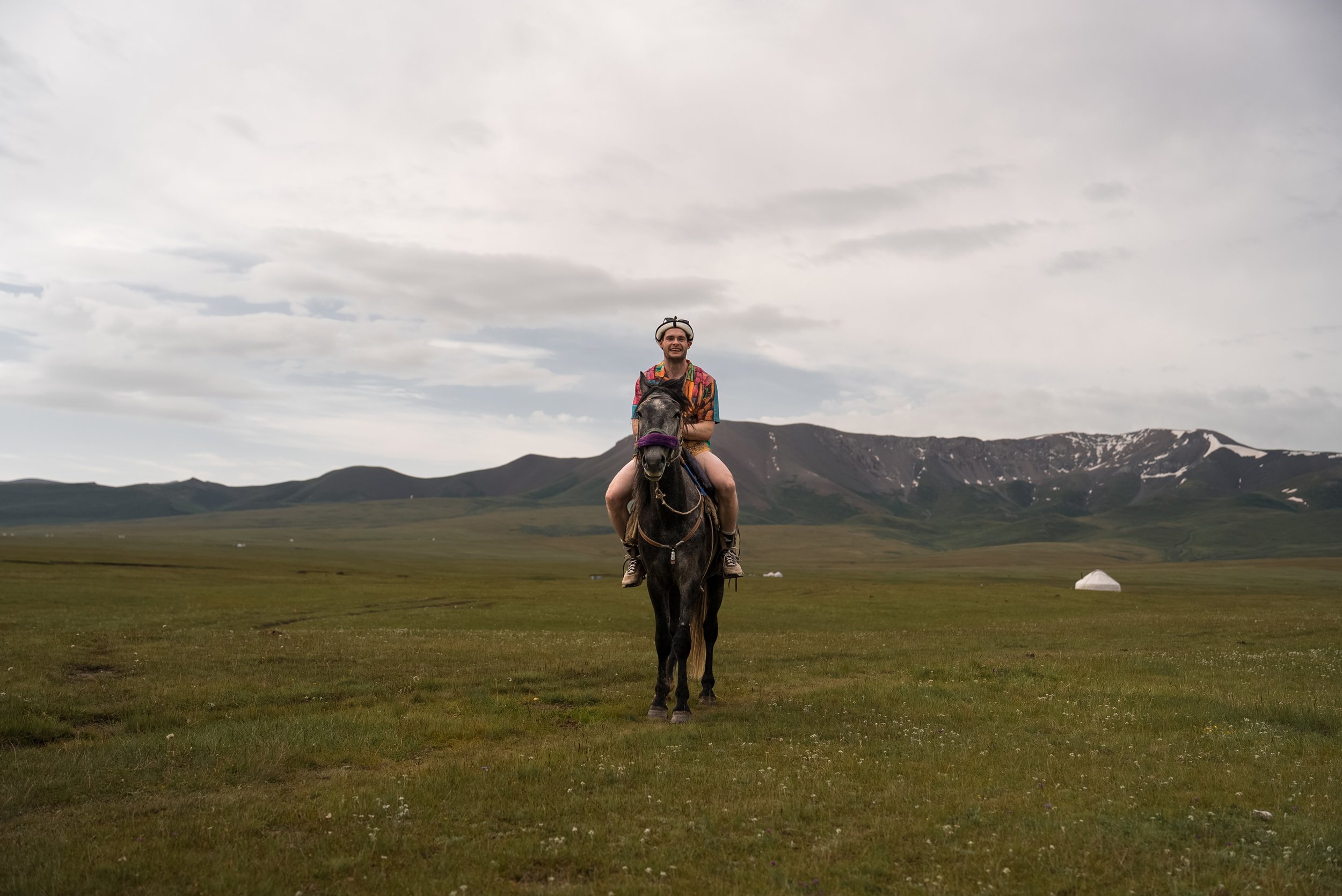 Horseriding across Song-Kul steppe in Kyrgyzstan