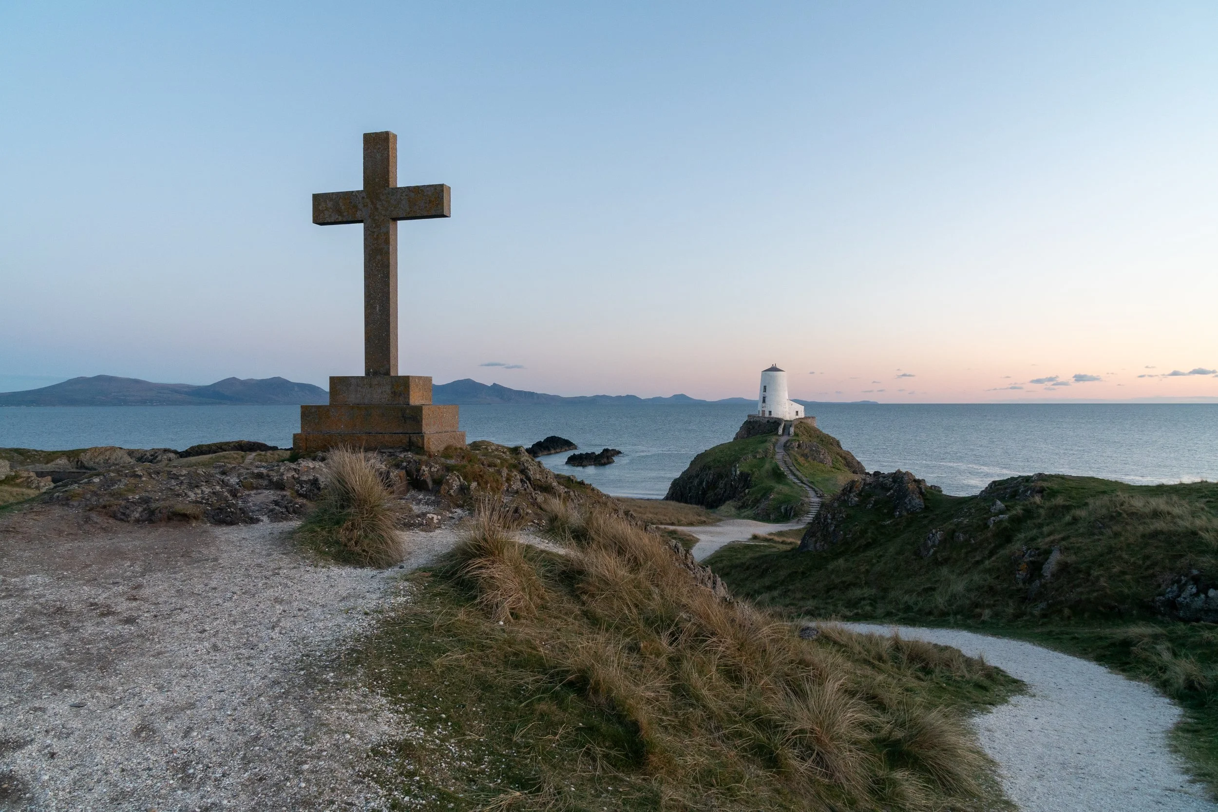Newborough Beach and Ynys Llanddwyn lighthouse at sunset, Anglesey North Wales