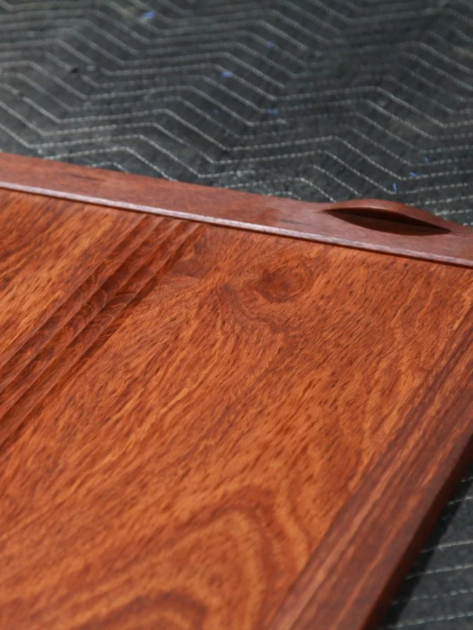 A cabinet door in jarrah with a fluted panel and integrated Eyeline handle by Evan Dunstone..jpg