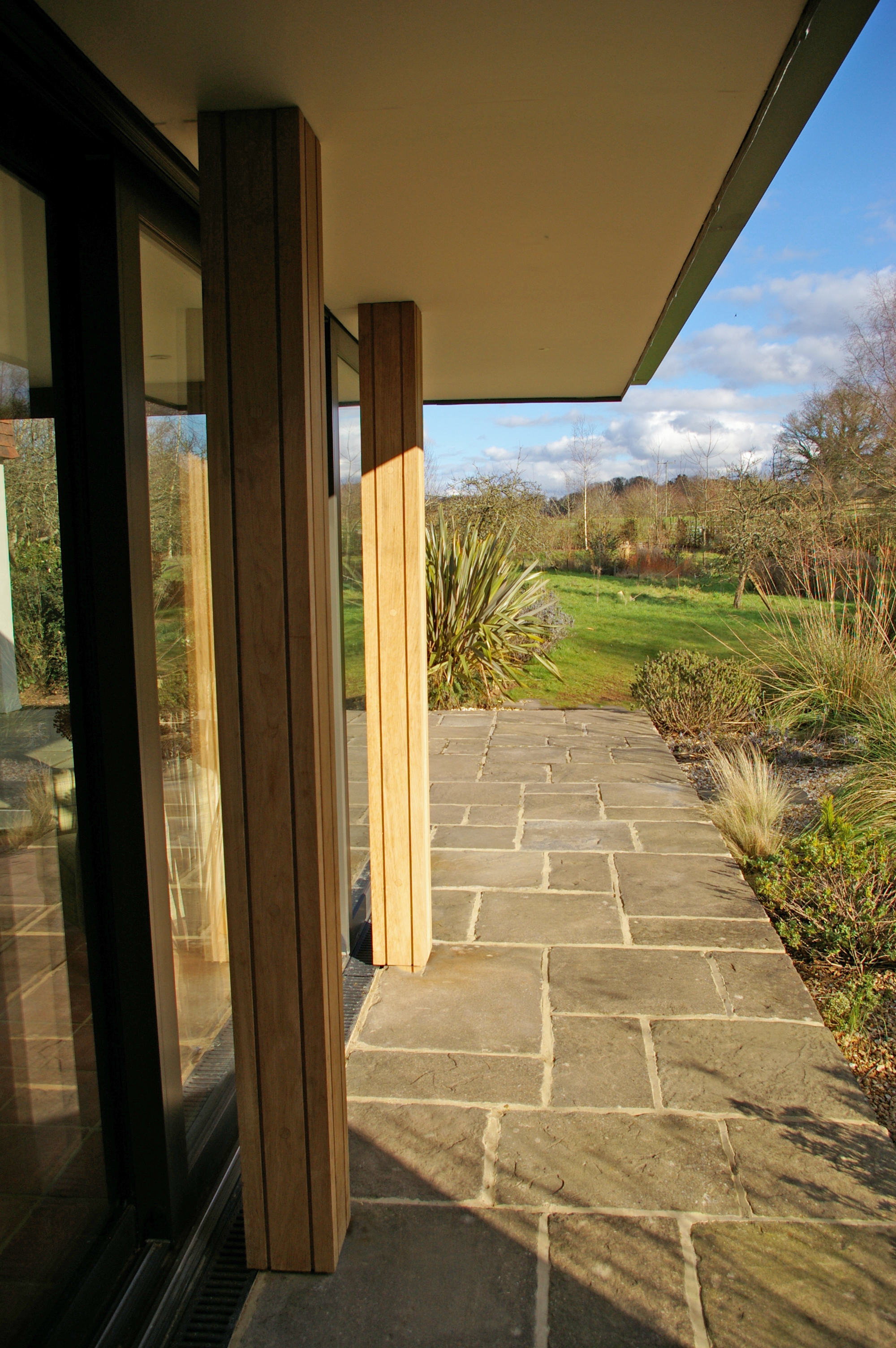 Walkway with oak columns and pathway to garden