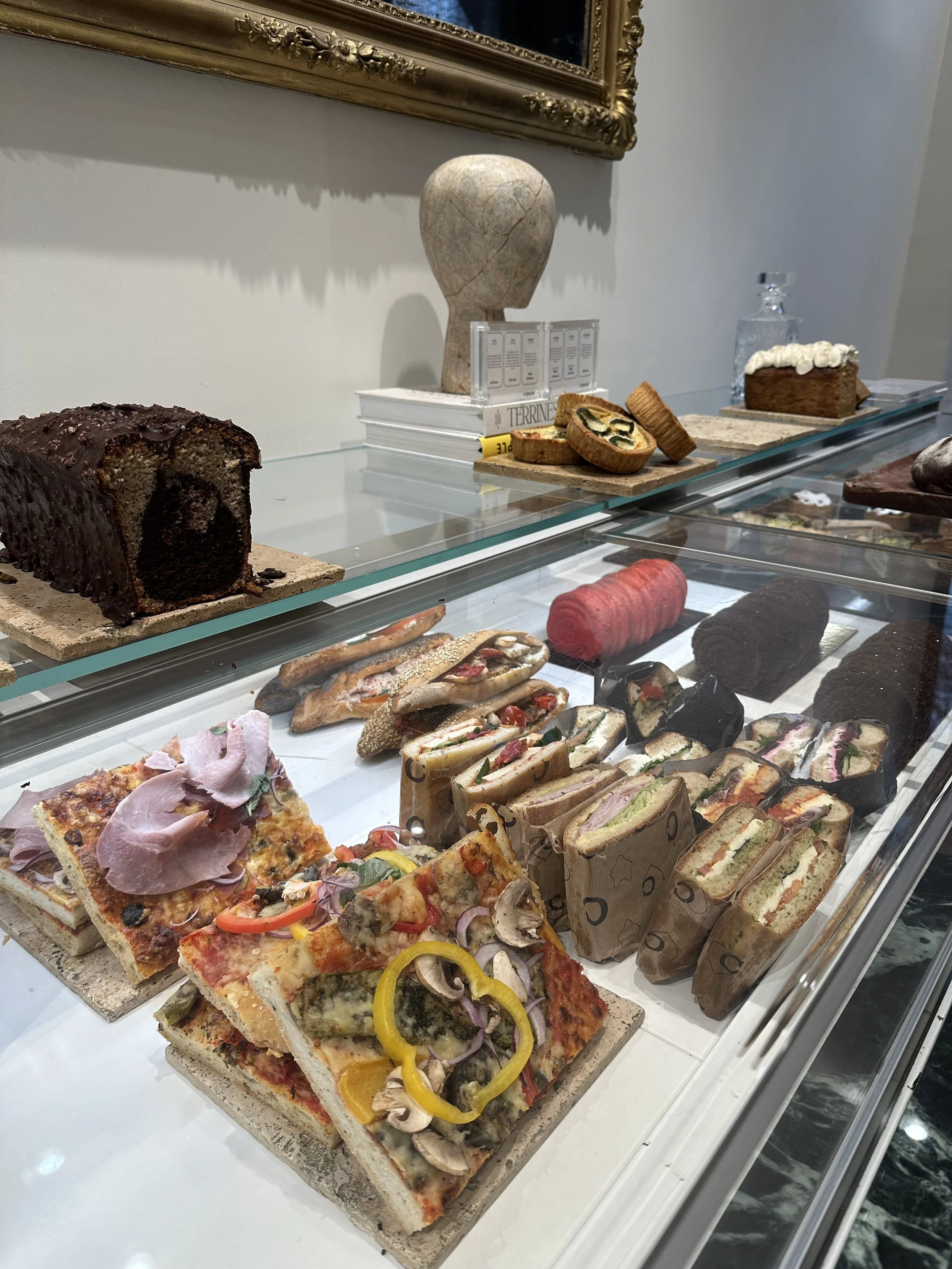 A display case filled with gluten free baked goods in Paris