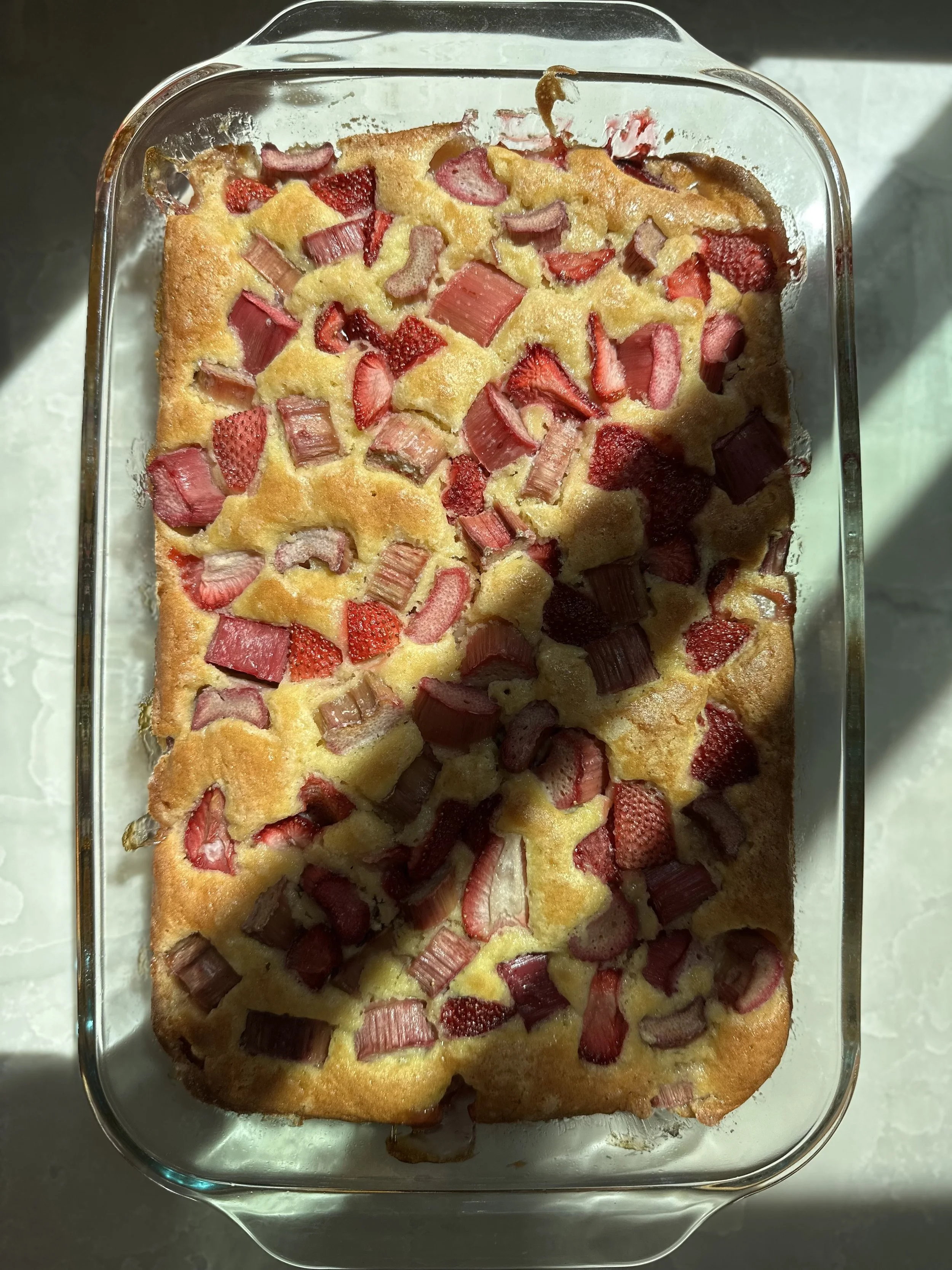 Cake in a 9x13 baking dish with strawberry & rhubarb
