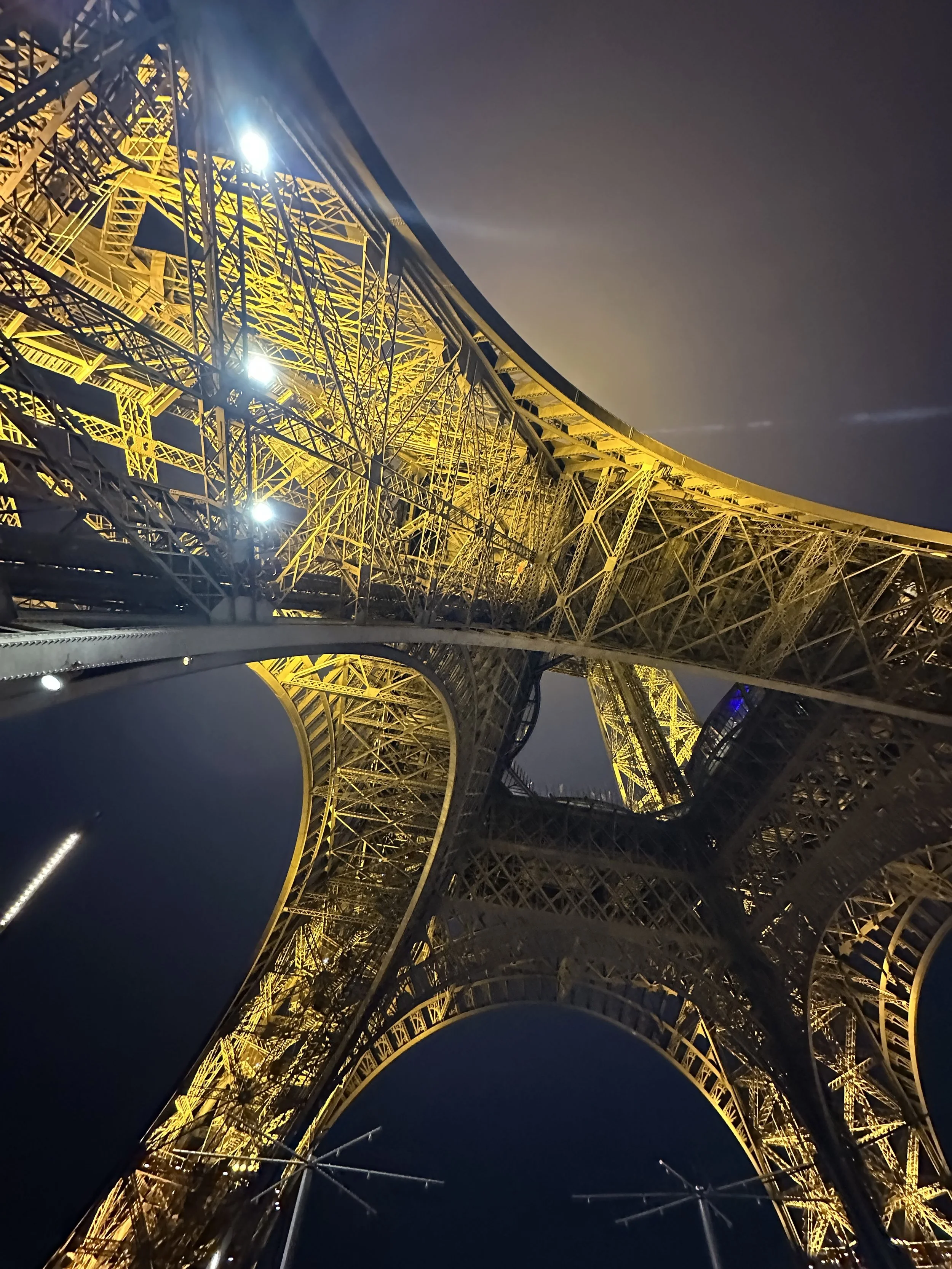 The Eiffel Tower at night, as seen from underneath the Eiffel Tower. Paris, Frace