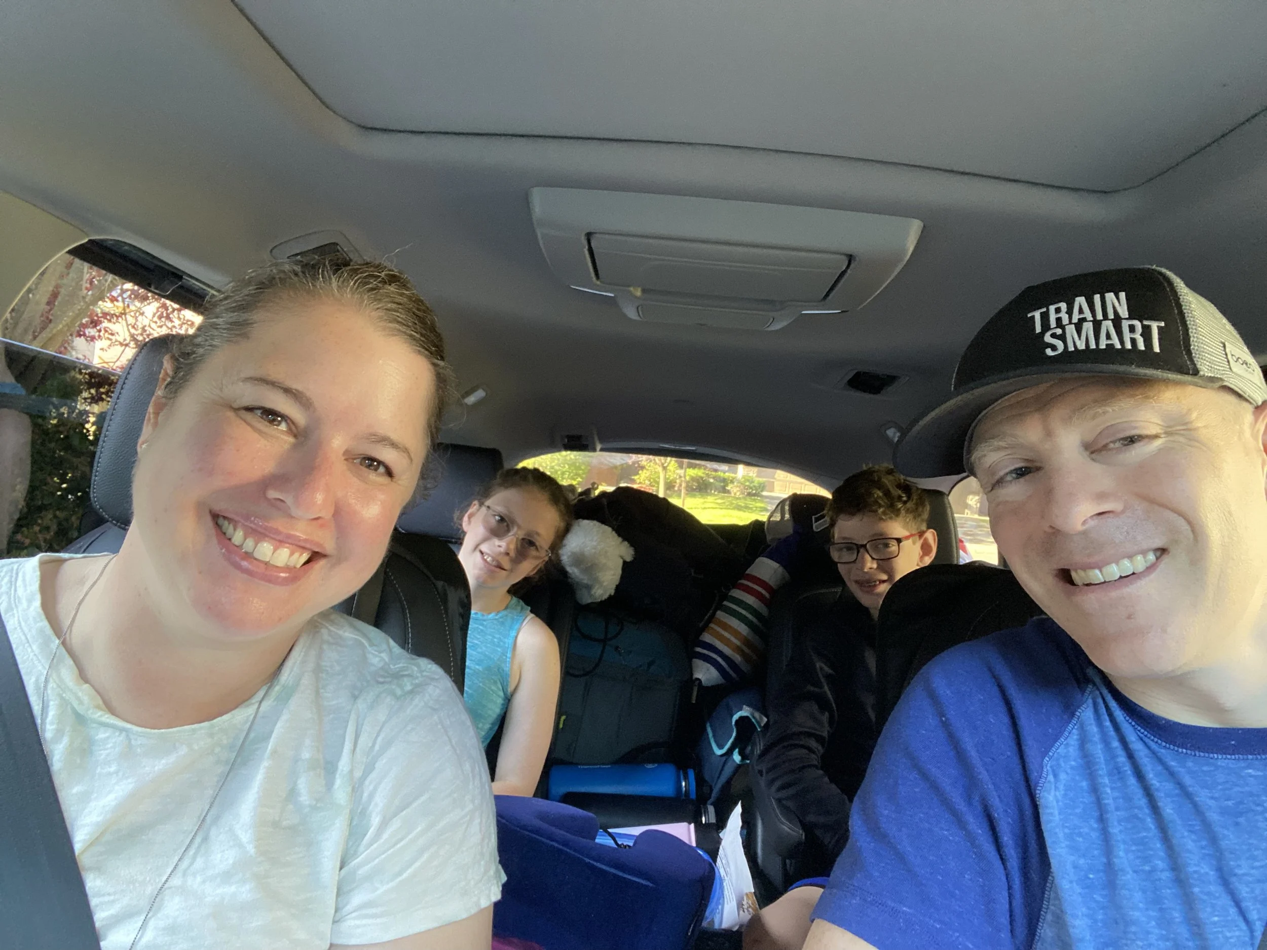 Family in a car leaving for a trip