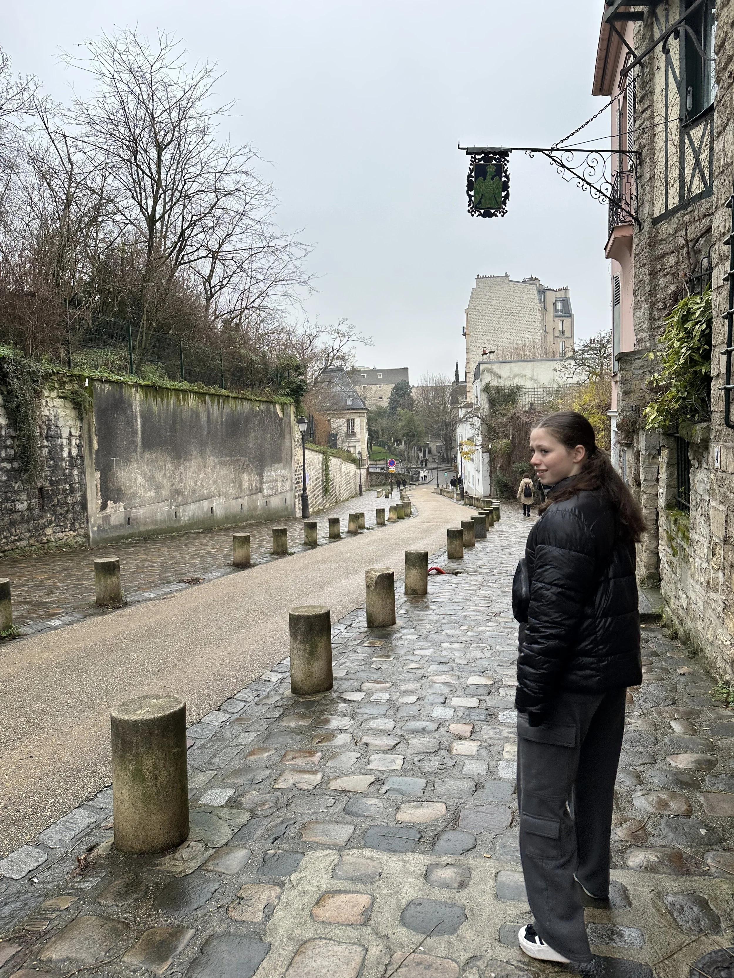 Teenage girl in Paris France on a street on a cloudy day.