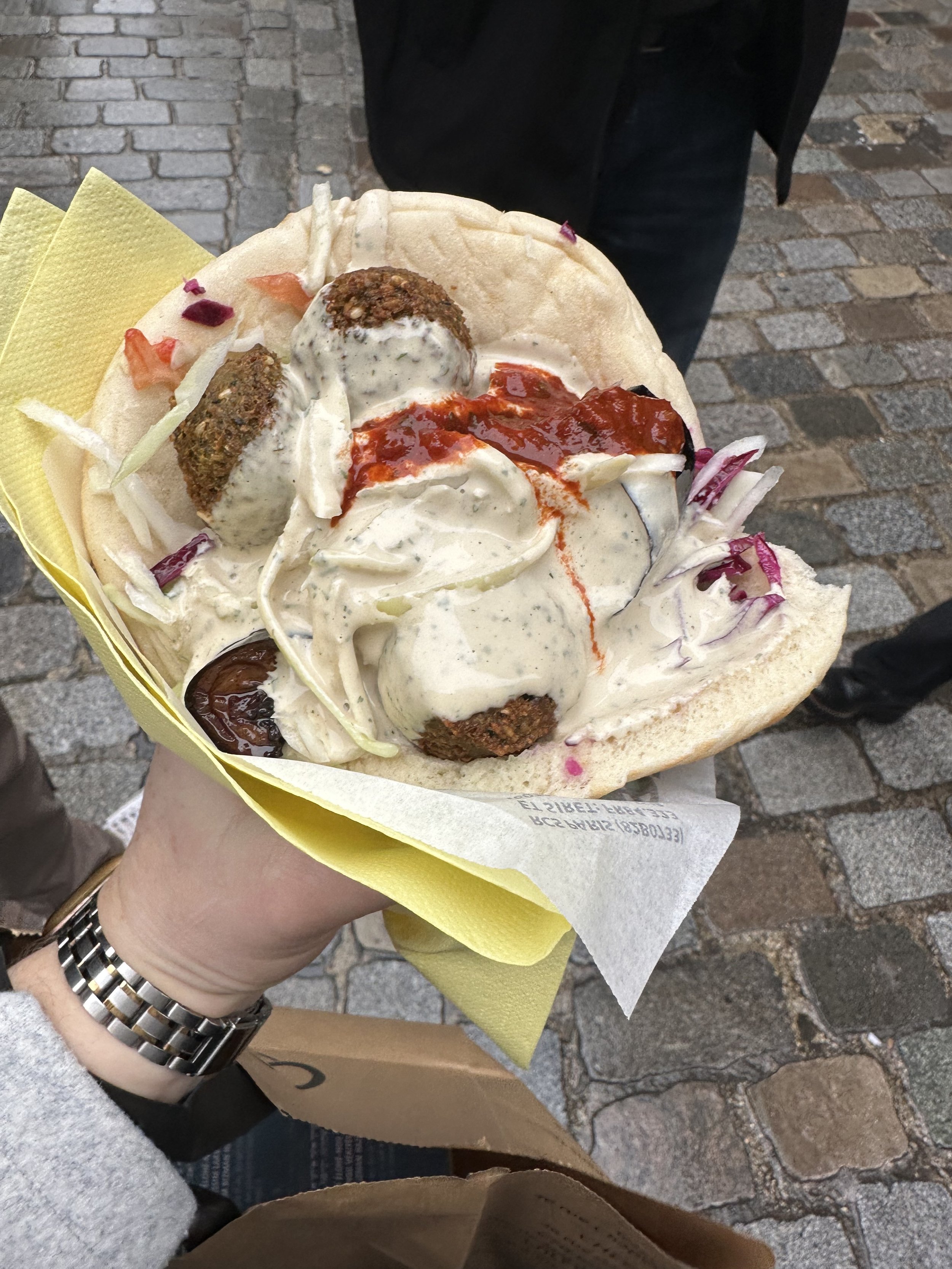 Falafal wrap from Las du falafell in Paris. Falafel covered in veggies & sauce