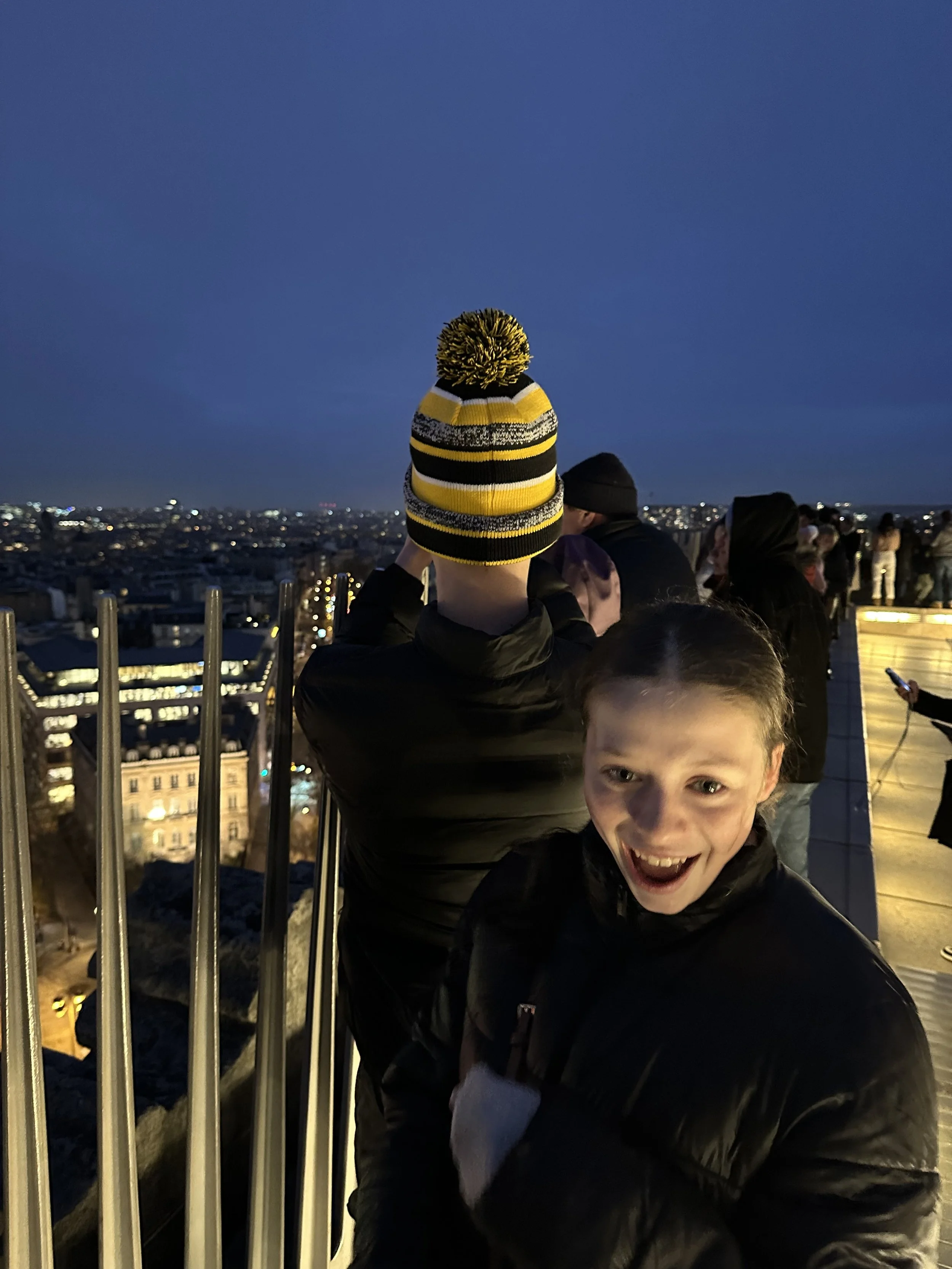 Two teenagers seeing the Paris skyline at night in Paris, France