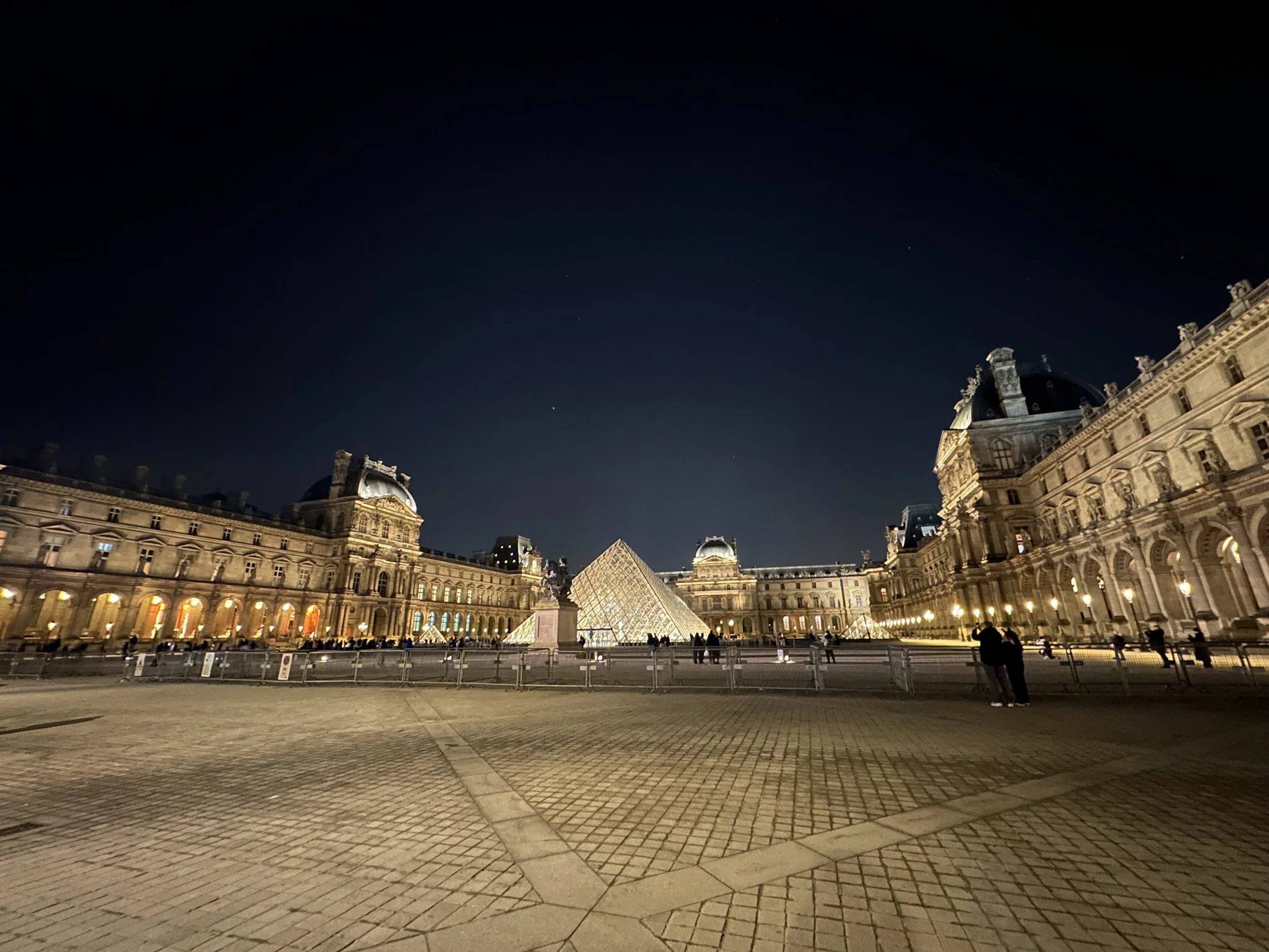 The Louvre & the Pyramid at night in Paris, France.