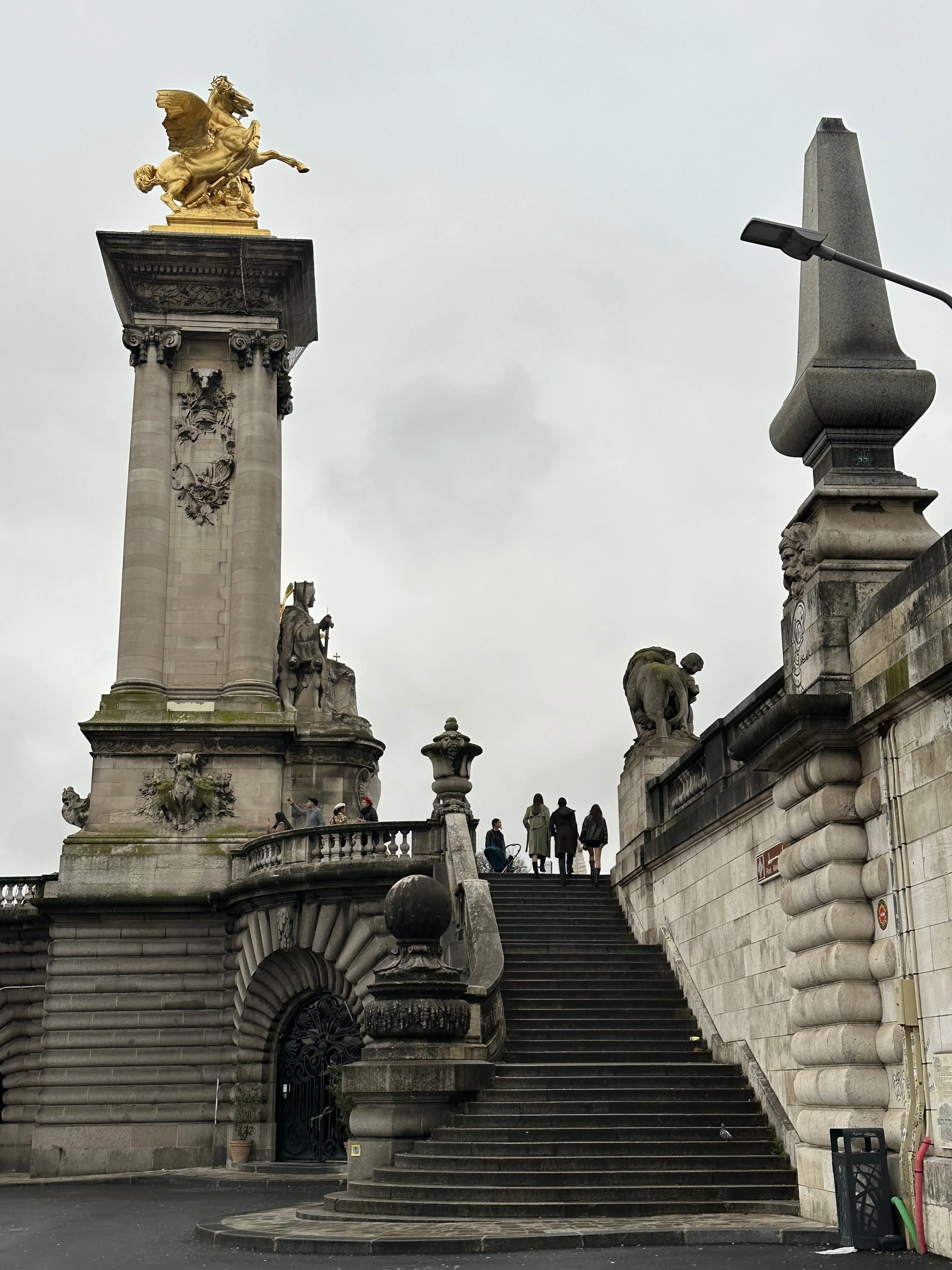 Along the Seine River in Paris. The staircase leading up to the Pont Alexandre Bridge in Paris, France.