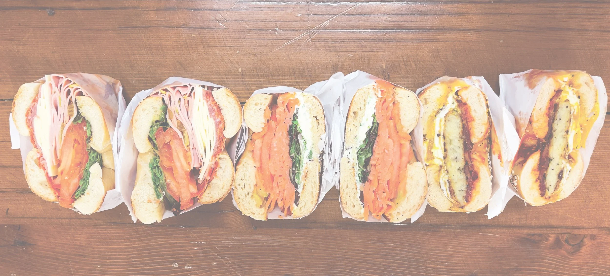 Assortment of bagel sandwiches with fresh toppings at Gotham Bagels in Chicago.jpg