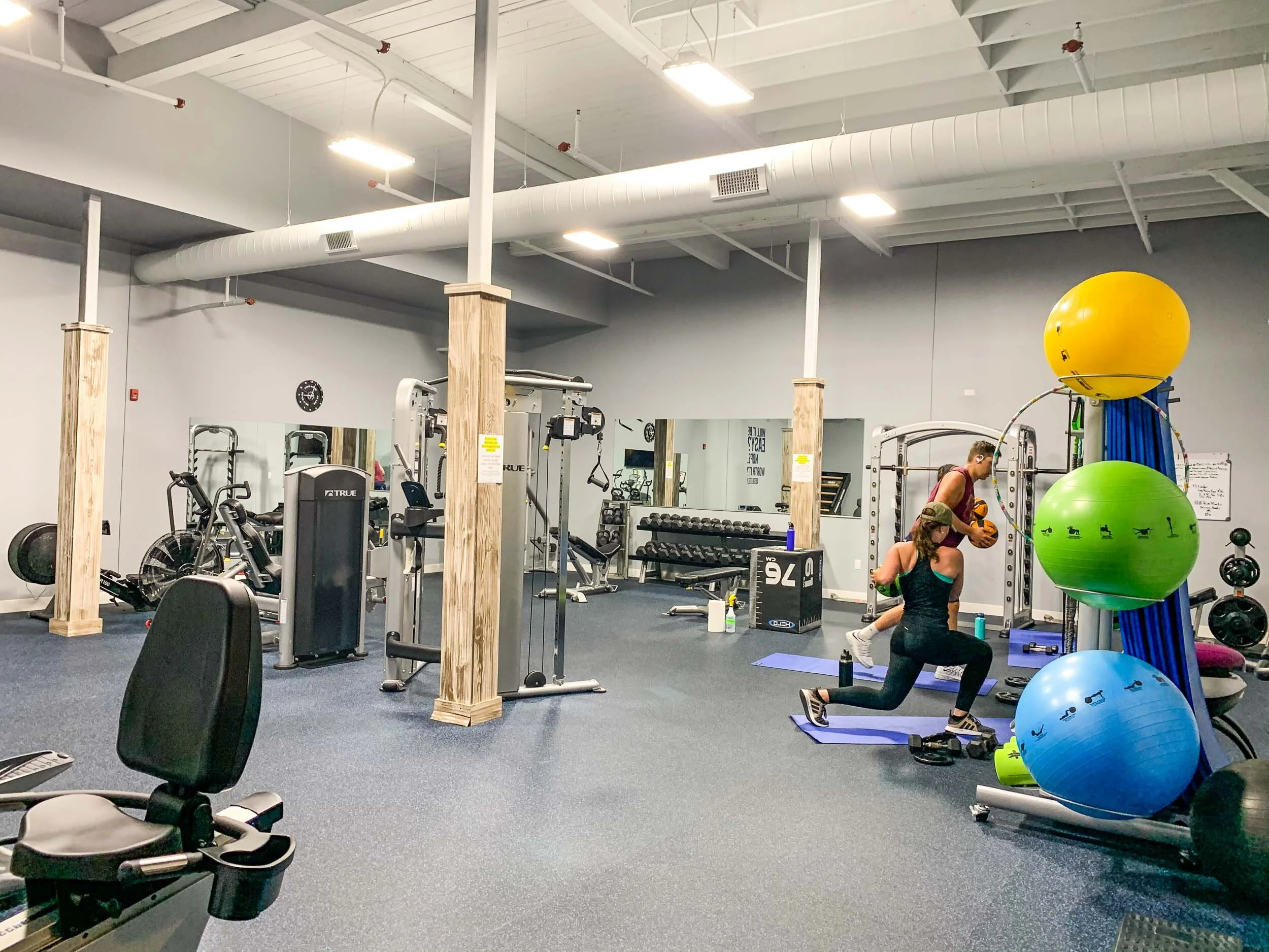 Modern fitness and wellness training space featuring functional gym equipment and personal training areas designed for movement, strength training, and wellness support.