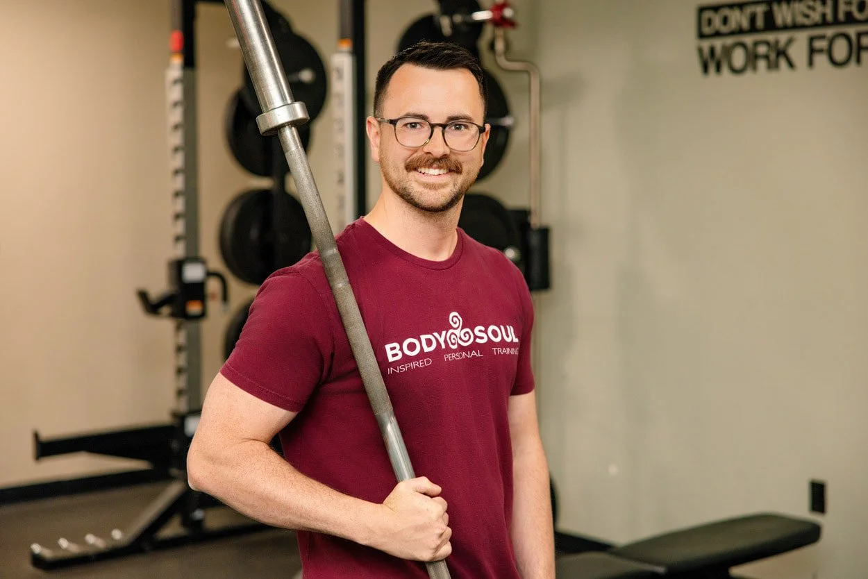Vincent Tanner personal trainer at Body Soul Training in Providence, Rhode Island, standing in the studio holding a barbell.