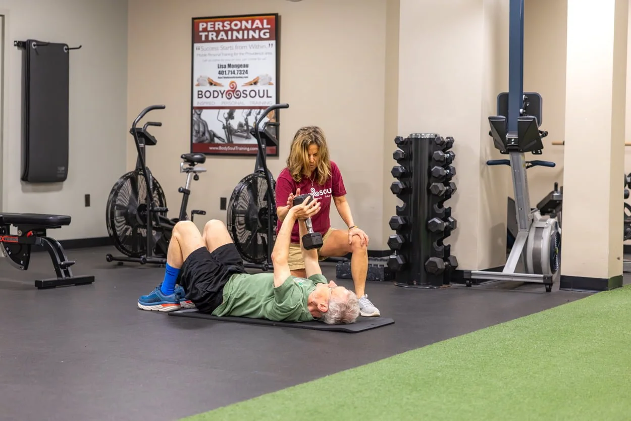 Personal trainer coaching a client during a strength training session at Body Soul Training in Providence, Rhode Island.