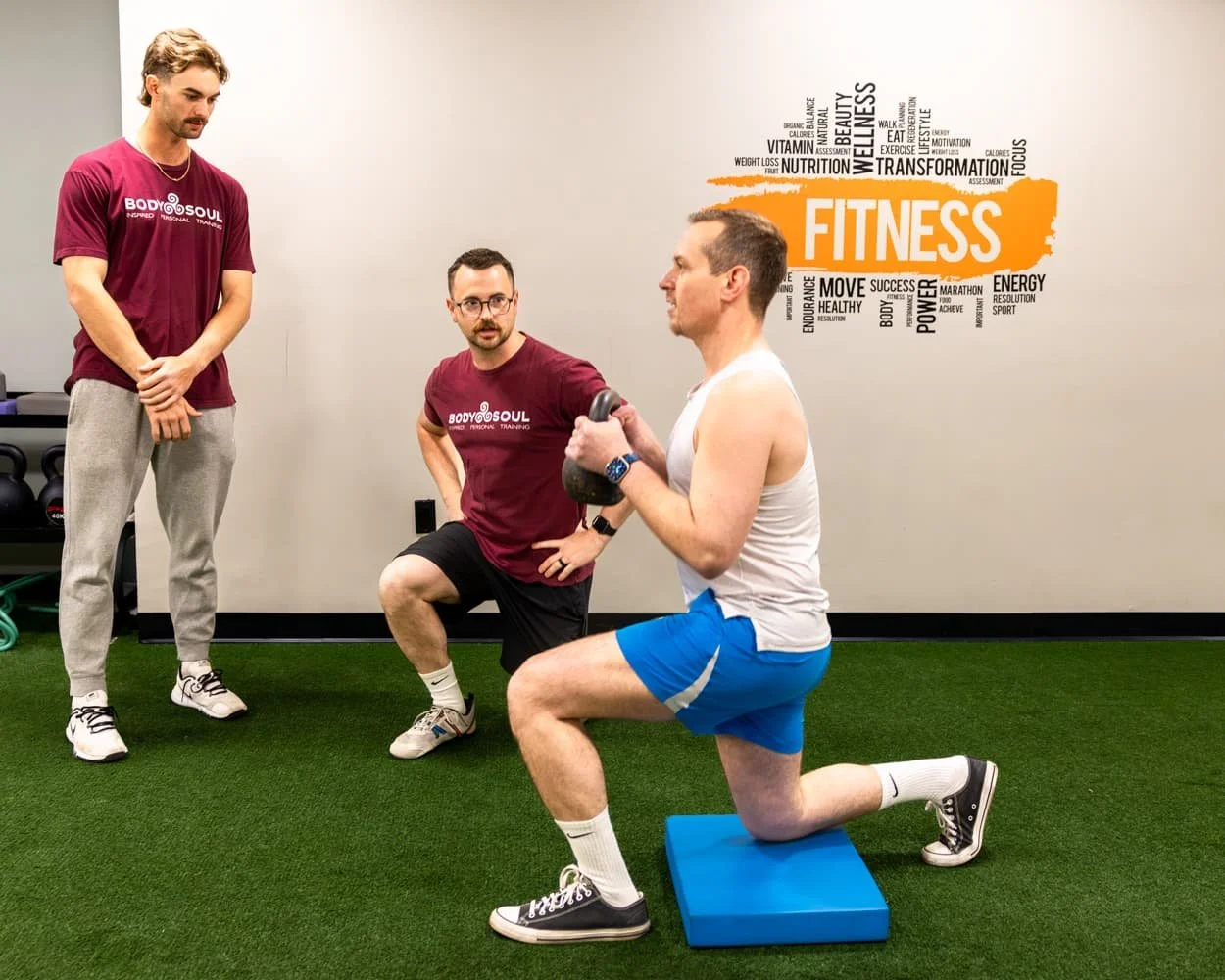 Personal trainers coaching a client during an in-studio personal training session at Body Soul Training in Providence, Rhode Island.
