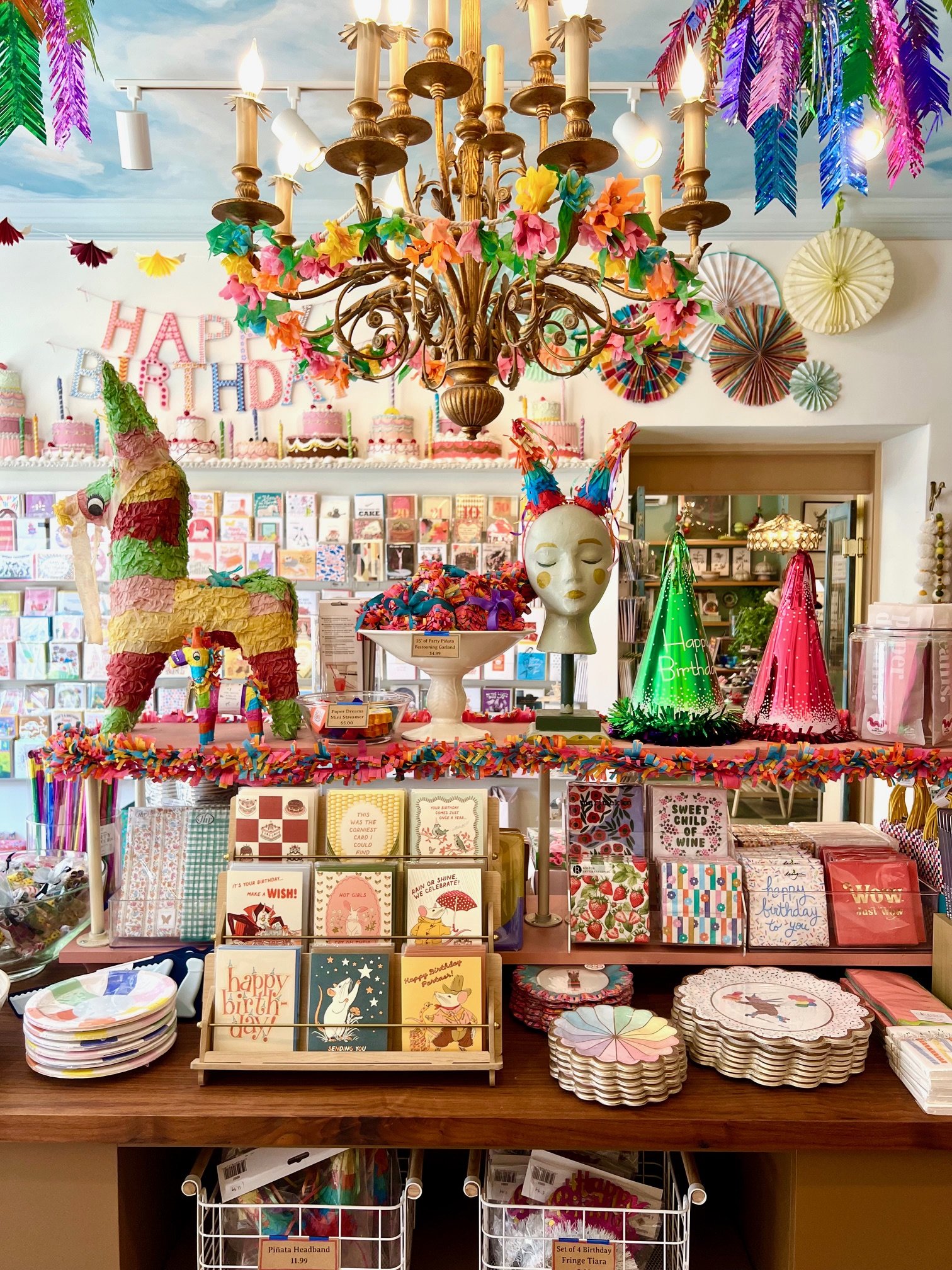 Inside of a party shop with piñatas and party hats