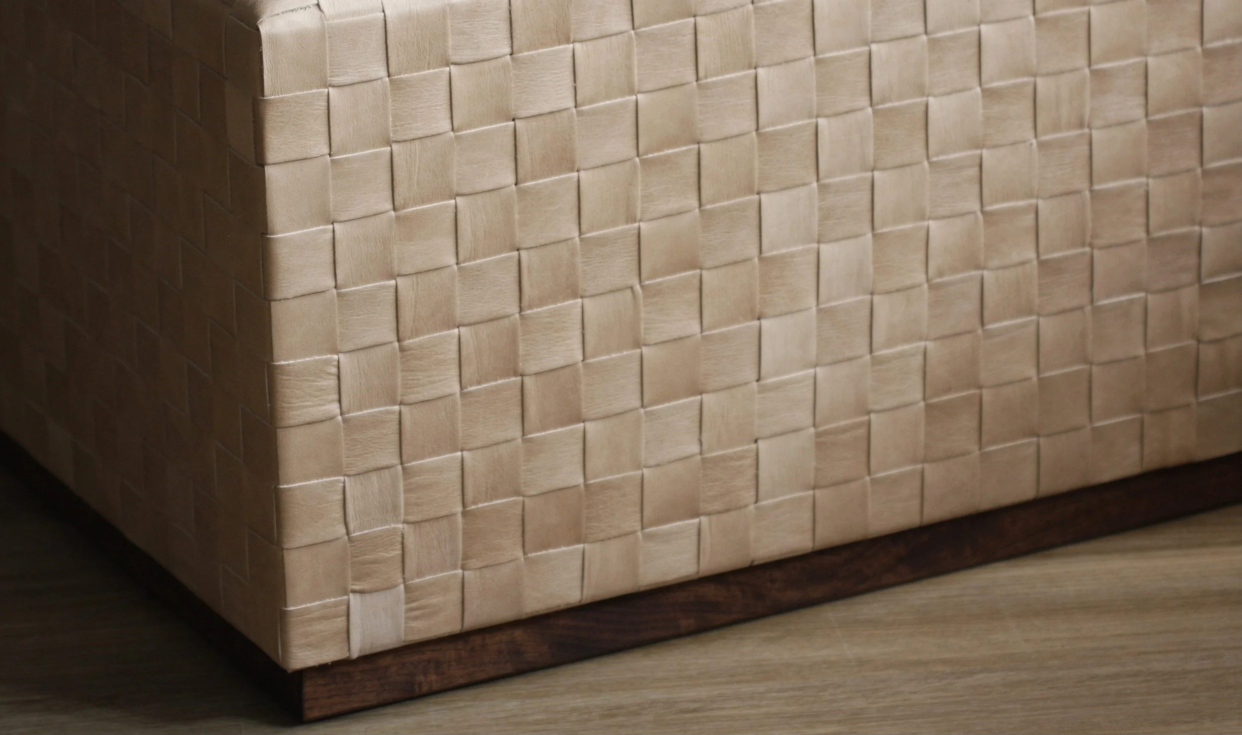 Close-up of a woven beige basket on a wooden surface.