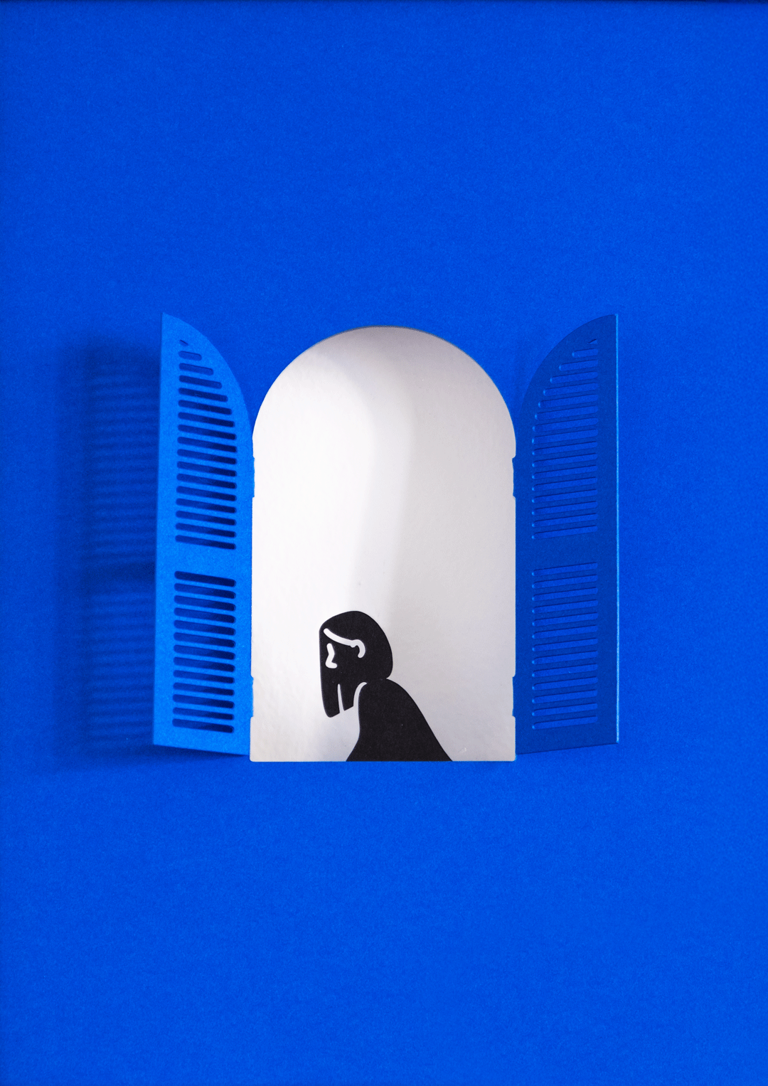 Double-sided paper cut frame depicting a woman at the window and an intimate scene inside.