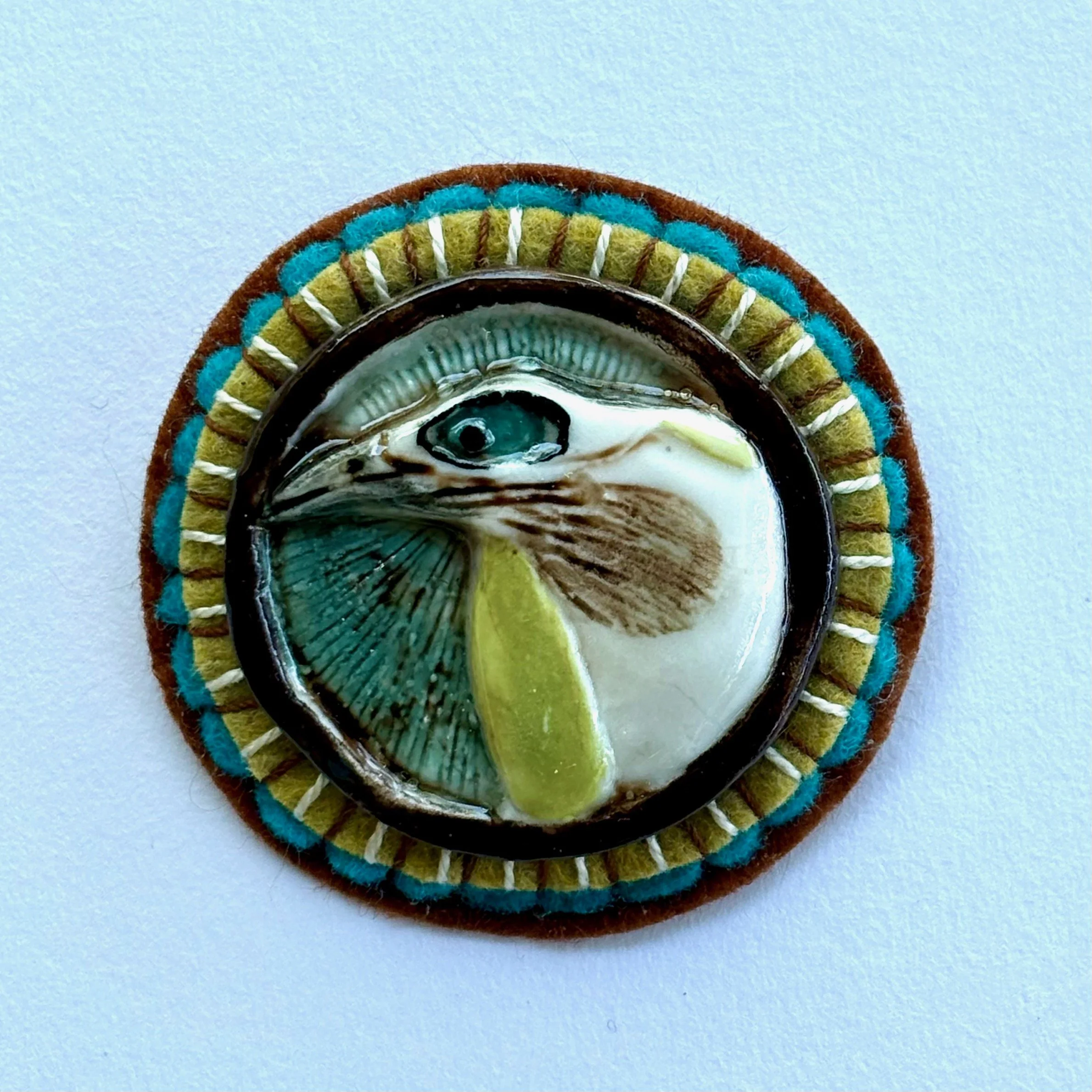 blue faced honey eater with olive and brown.jpeg