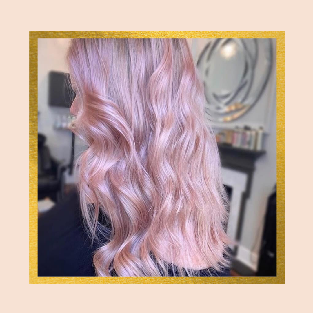 Woman with wavy pastel pink hair in salon