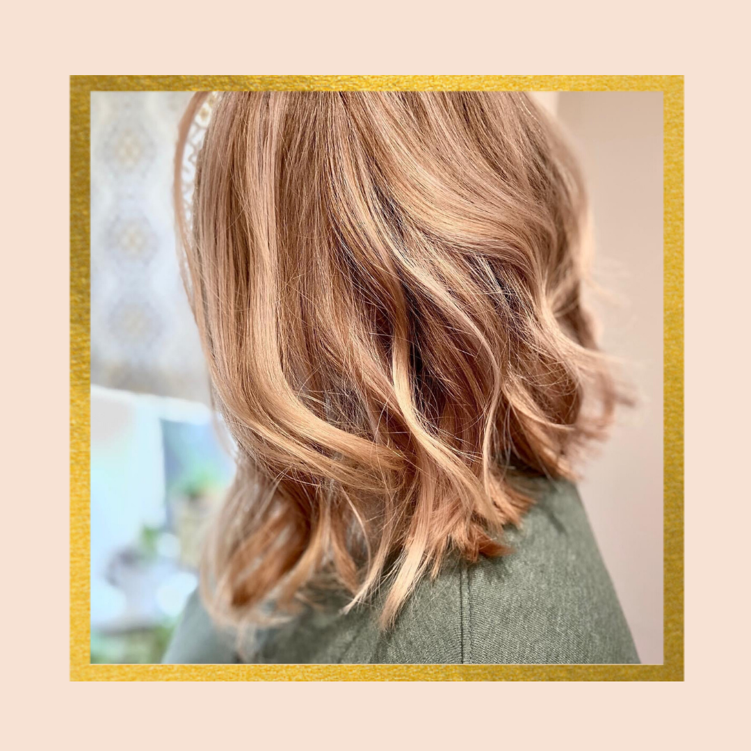 Wavy light brown hair styled in a bob cut, framed by a gold border.