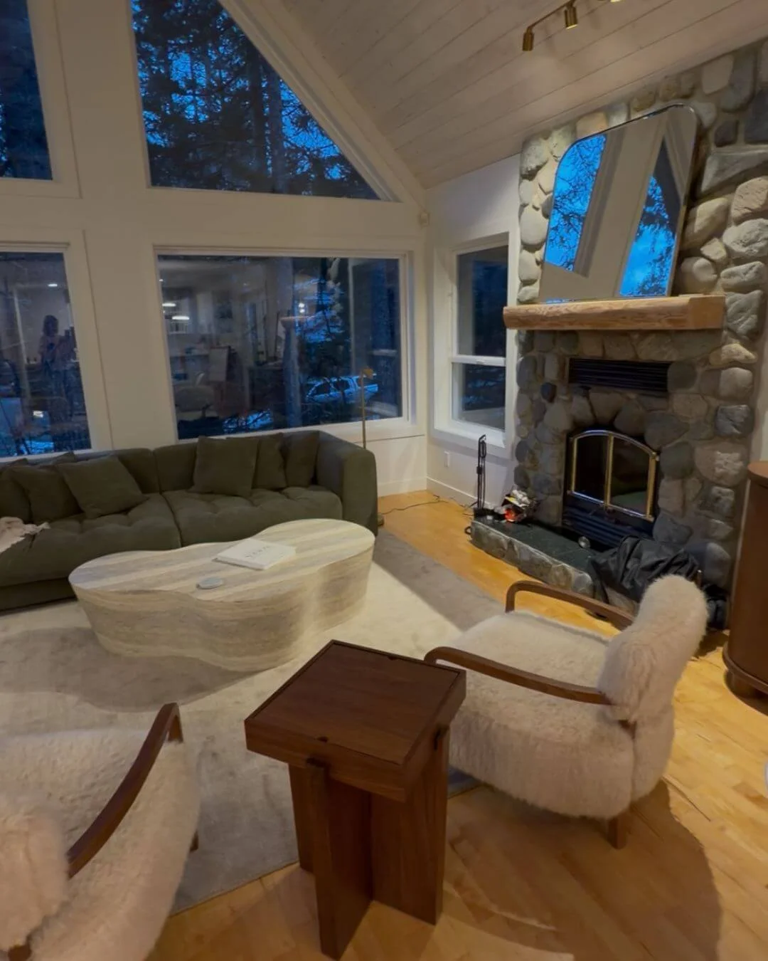 Whistler living room with stone fireplace, wood accents, and organic modern furnishings